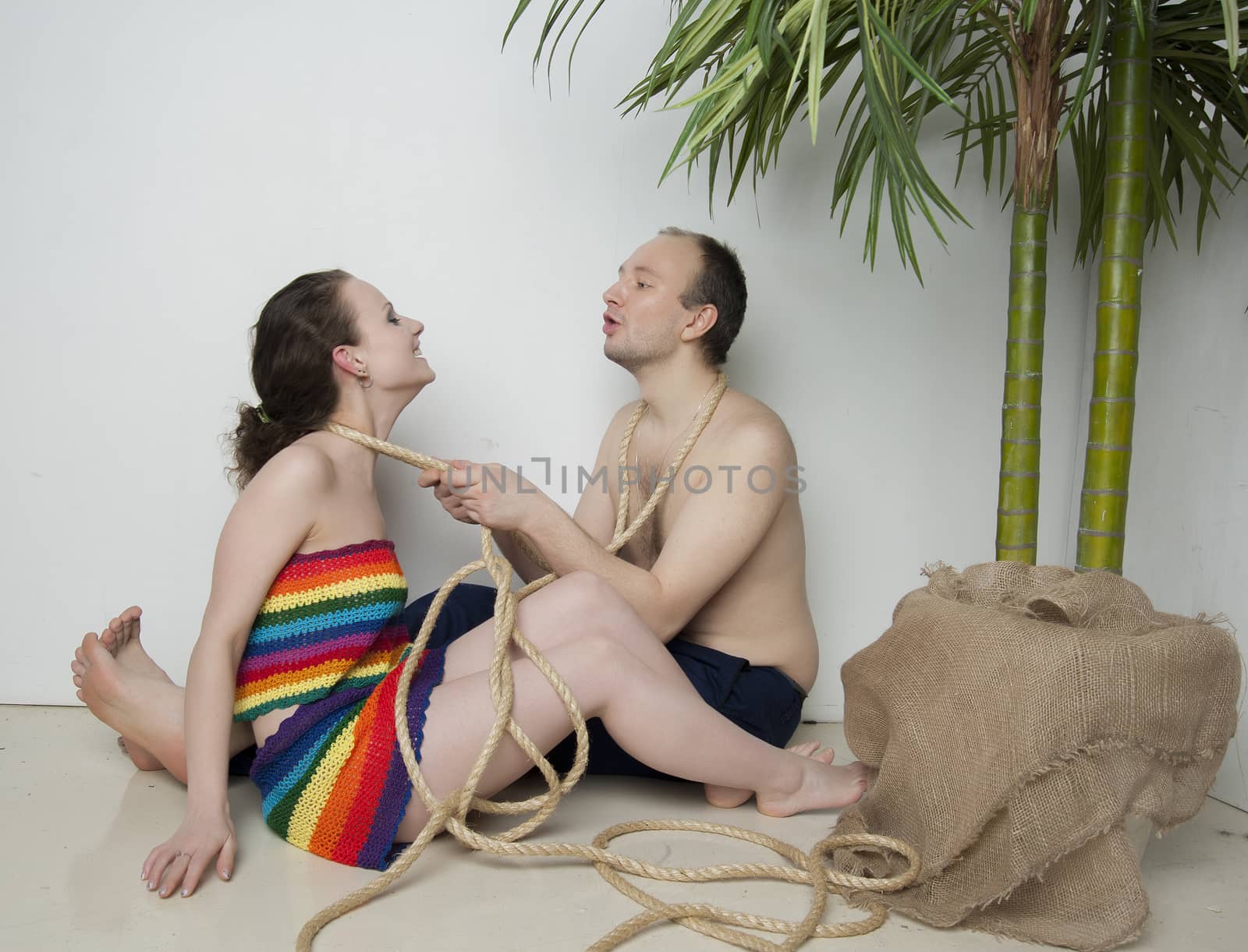 young couple under a palm tree in the Studio