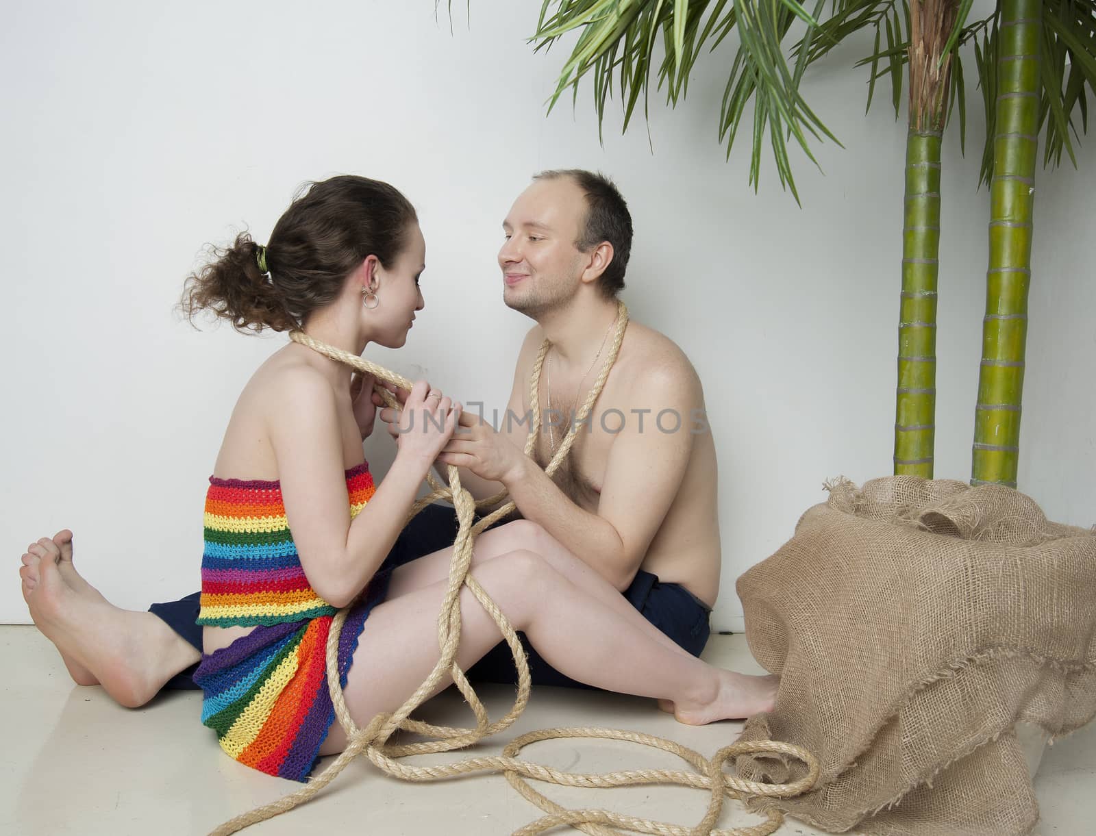 young couple under a palm tree in the Studio