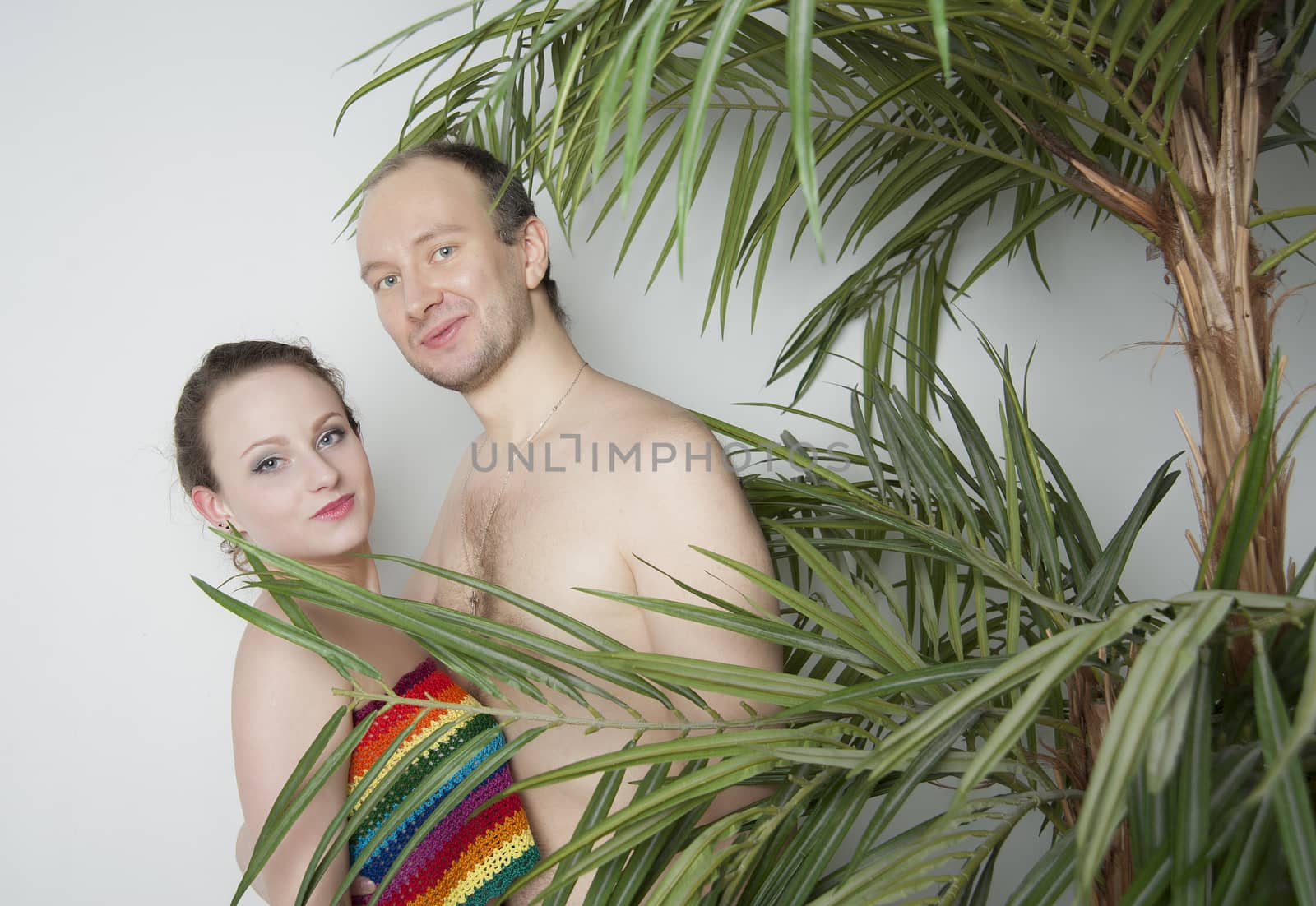 young couple under a palm tree in the Studio