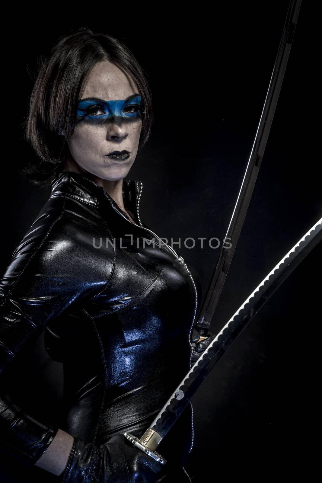 Woman with katana sword in latex costume