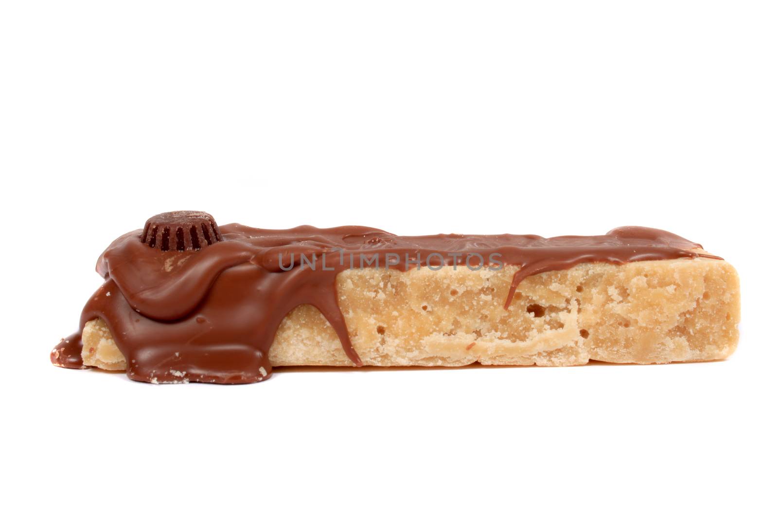 Maple or butterscotch fudge covered in chocolate on a white background