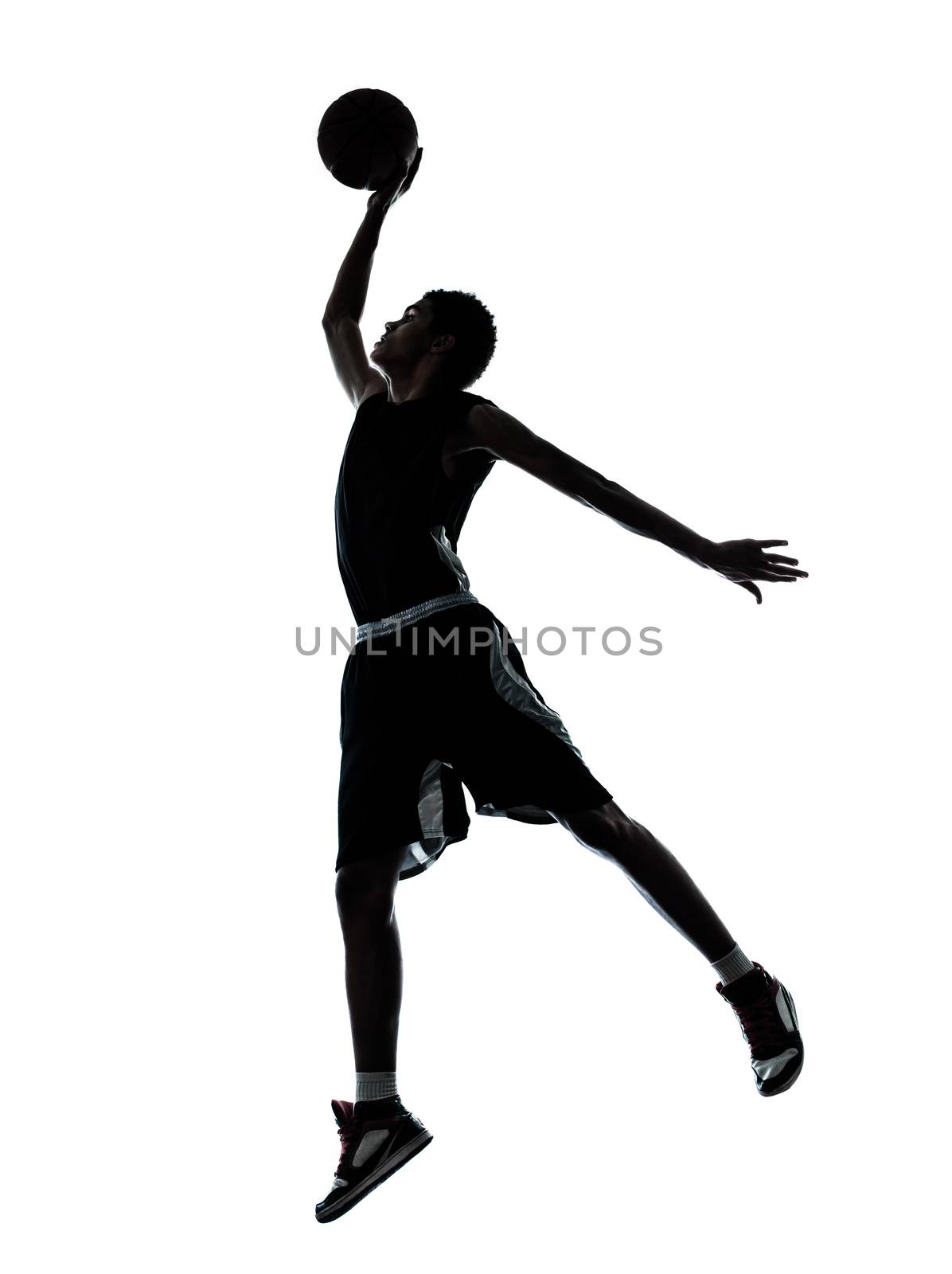 one young man basketball player dunking silhouette in studio isolated on white background