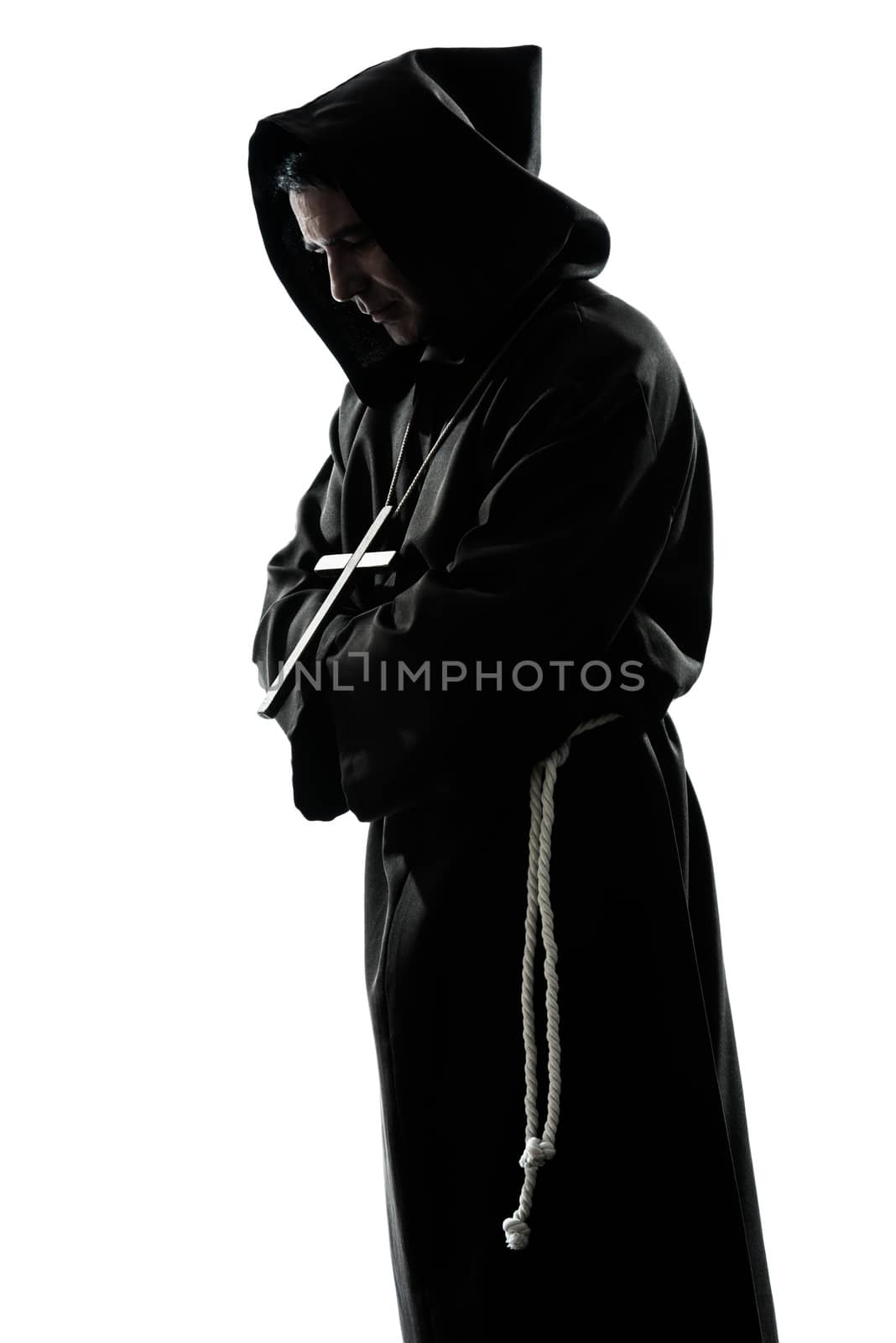 one caucasian man priest praying silhouette in studio isolated on white background