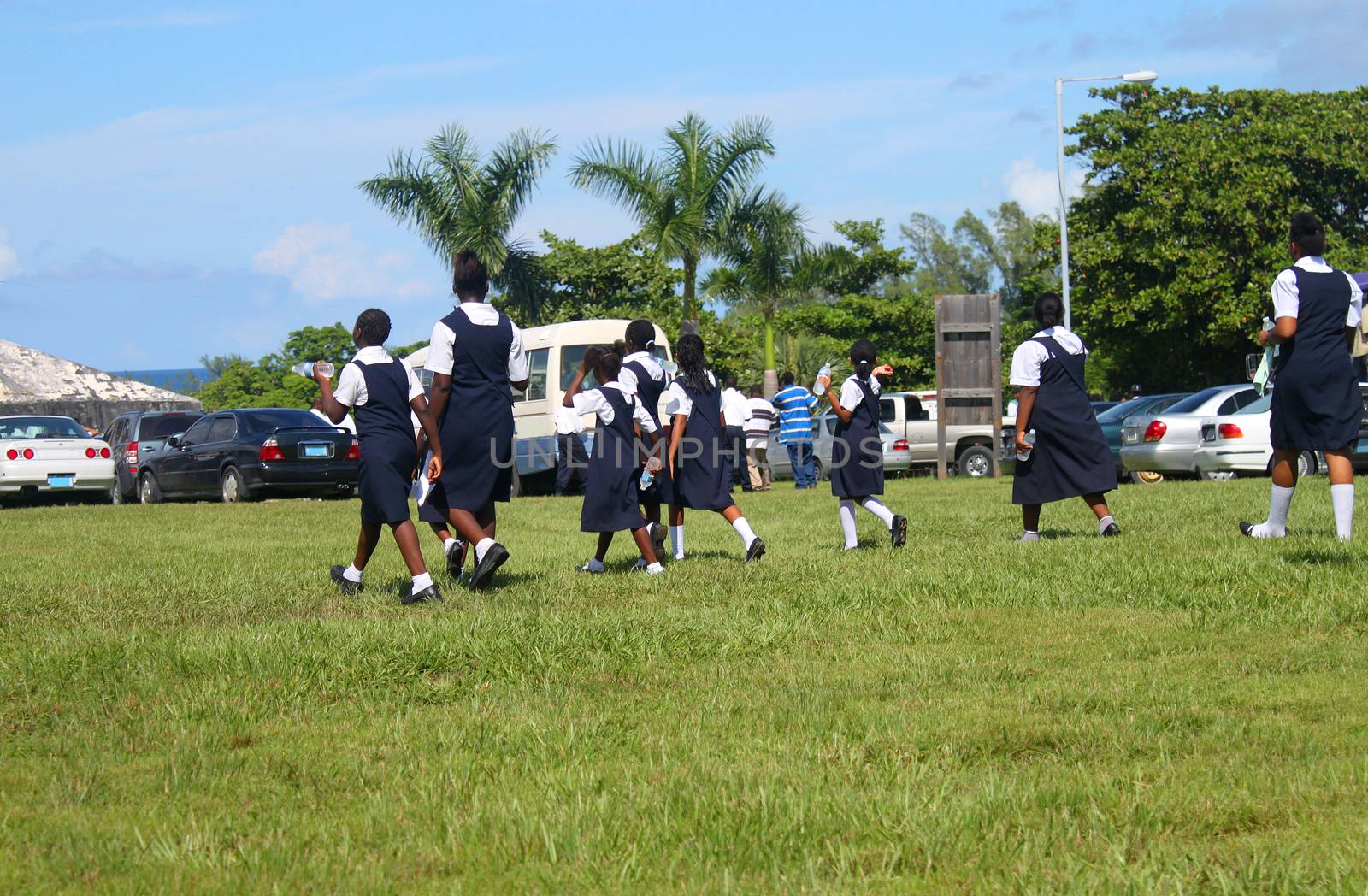 Students from the Bahamas dressed in school uniform go to a gathering or festival in the outdoors in Nassau