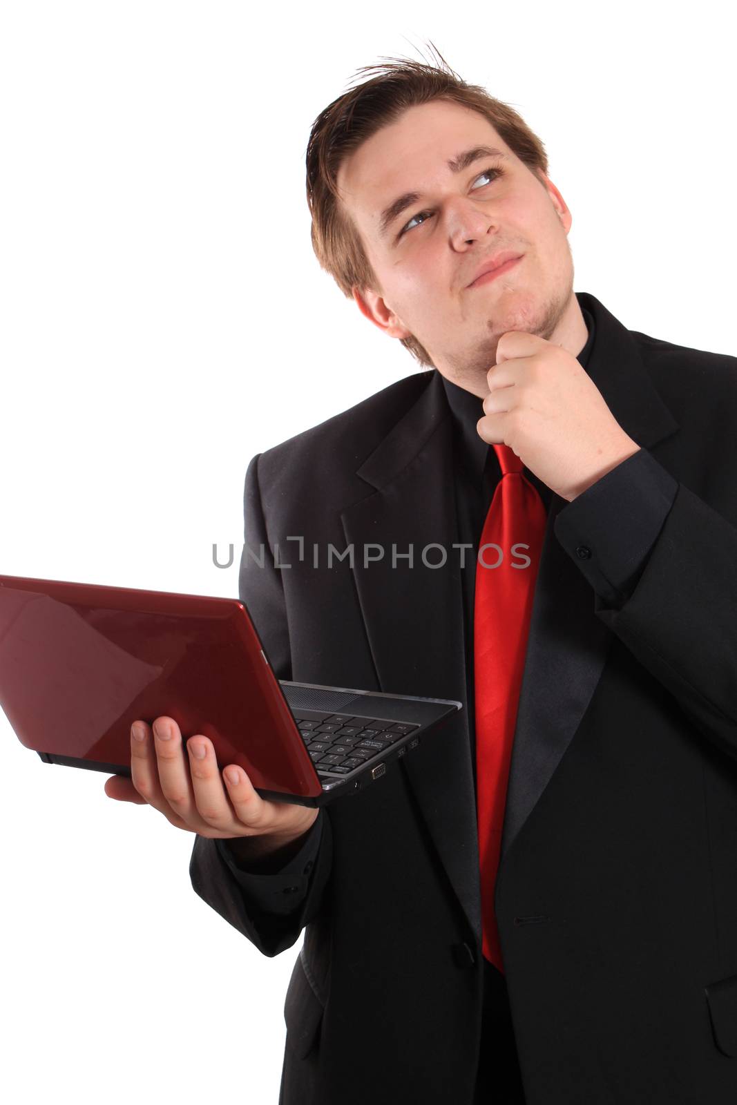 Handsome young businessman holding small computer laptop with a wondering expression on white background