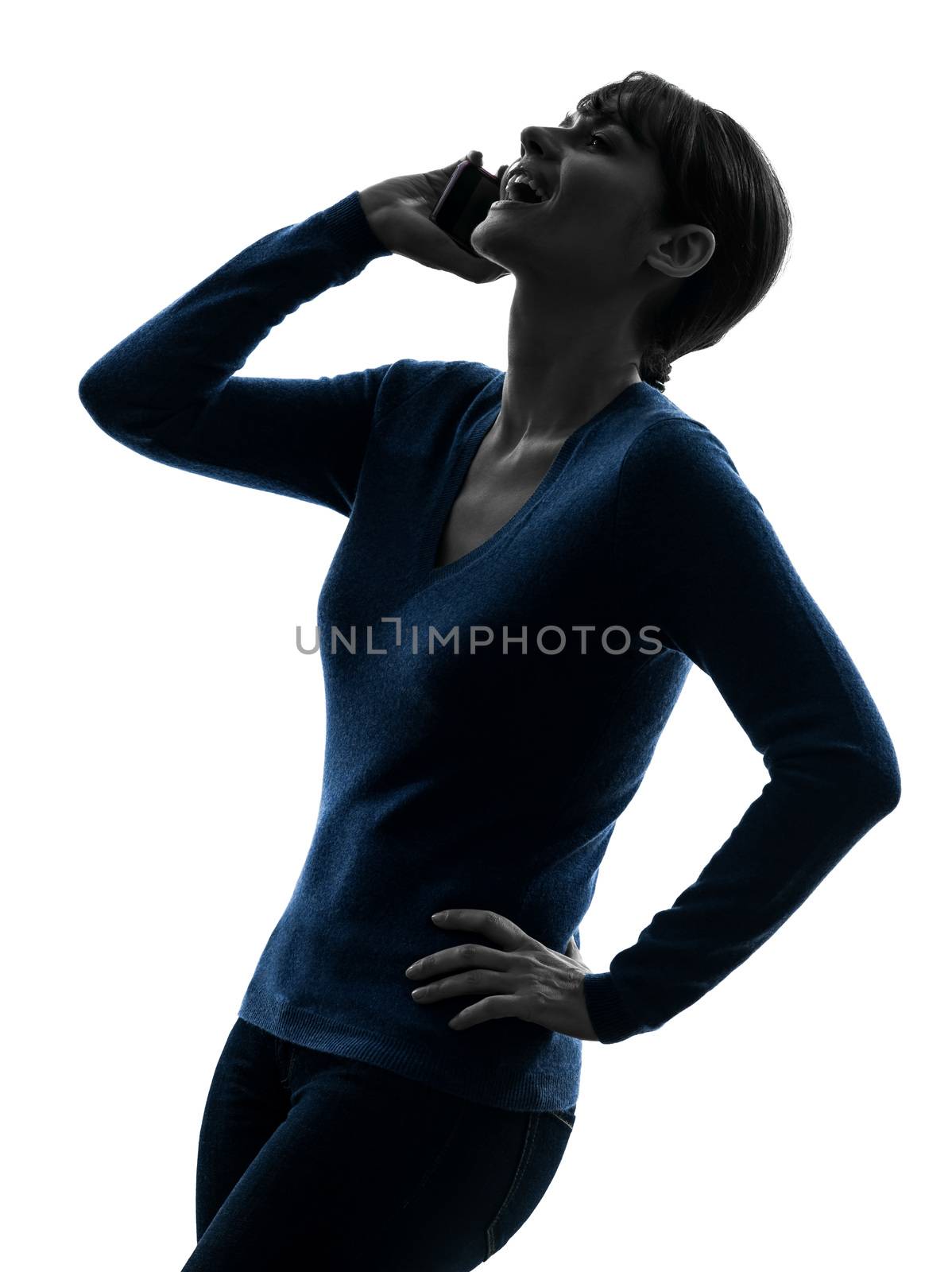 one caucasian woman laughing   on the telephone in silhouette studio isolated on white background