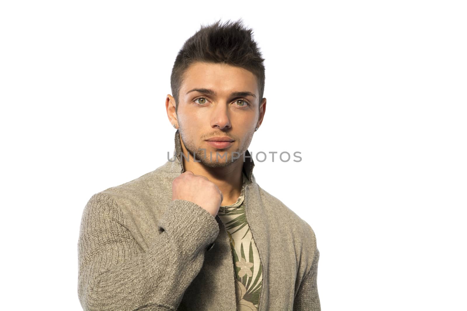 Handsome young man with wool sweater on white background looking at camera