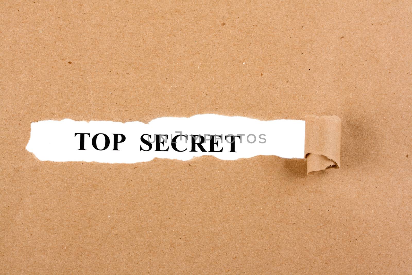 Word top secret appears under the torn brown paper