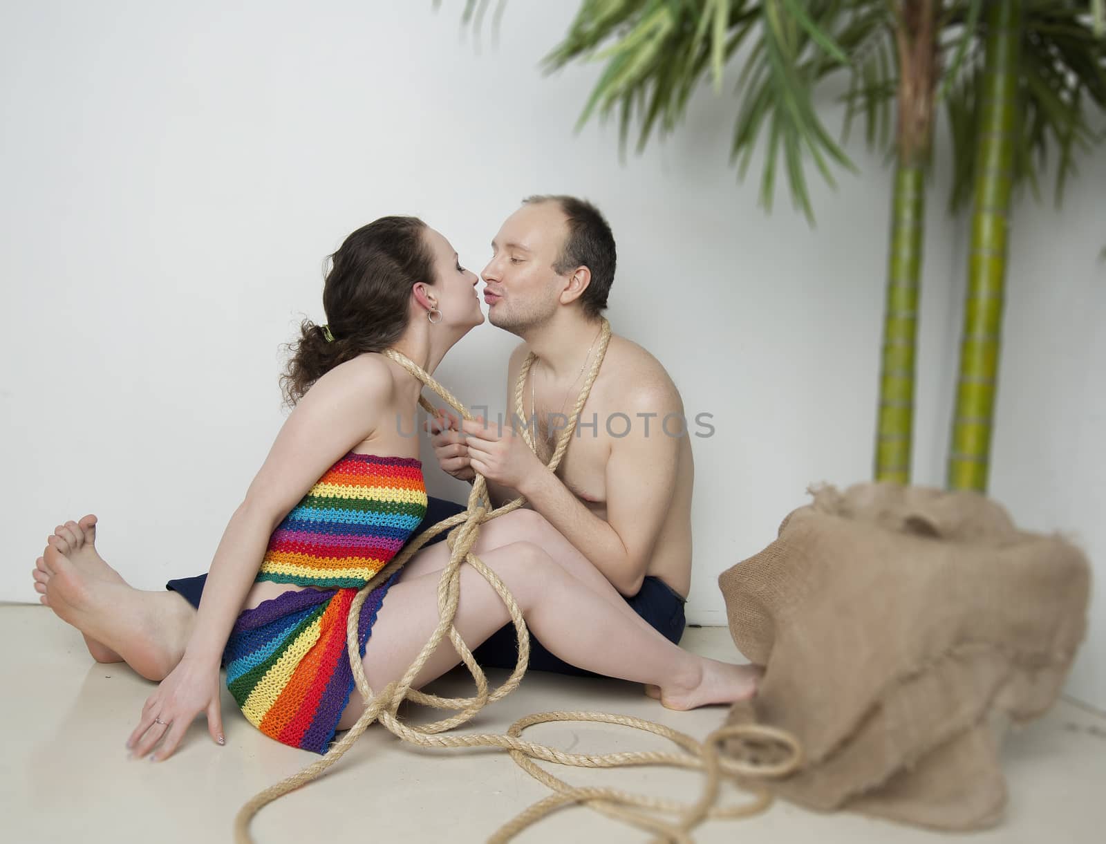 young couple under a palm tree in the Studio