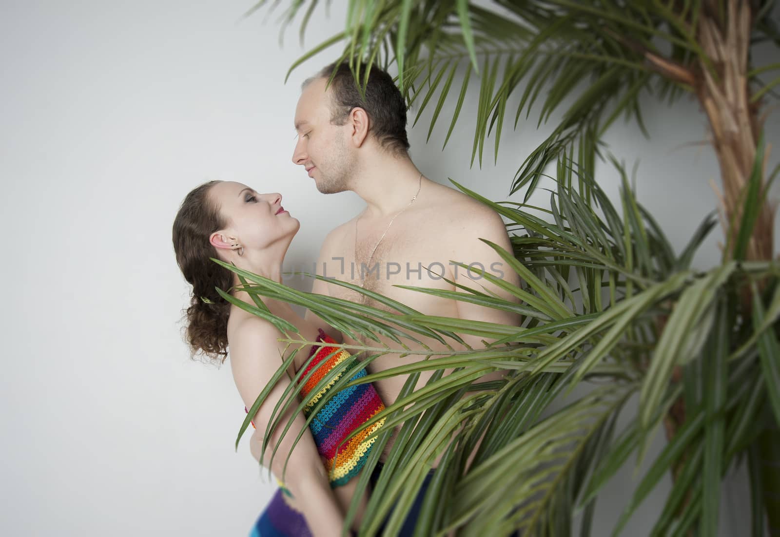 young couple under a palm tree in the Studio