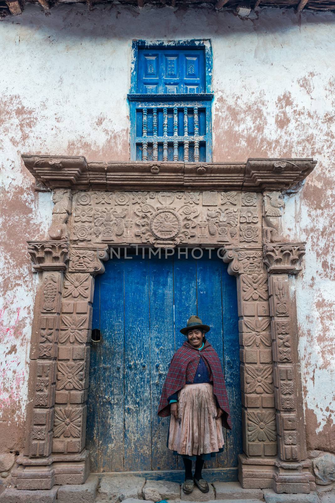 Moray, Peru - July 15, 2013: woman in front of ancient door in the peruvian Andes at Moray in Cuzco Peru on july 15, 2013