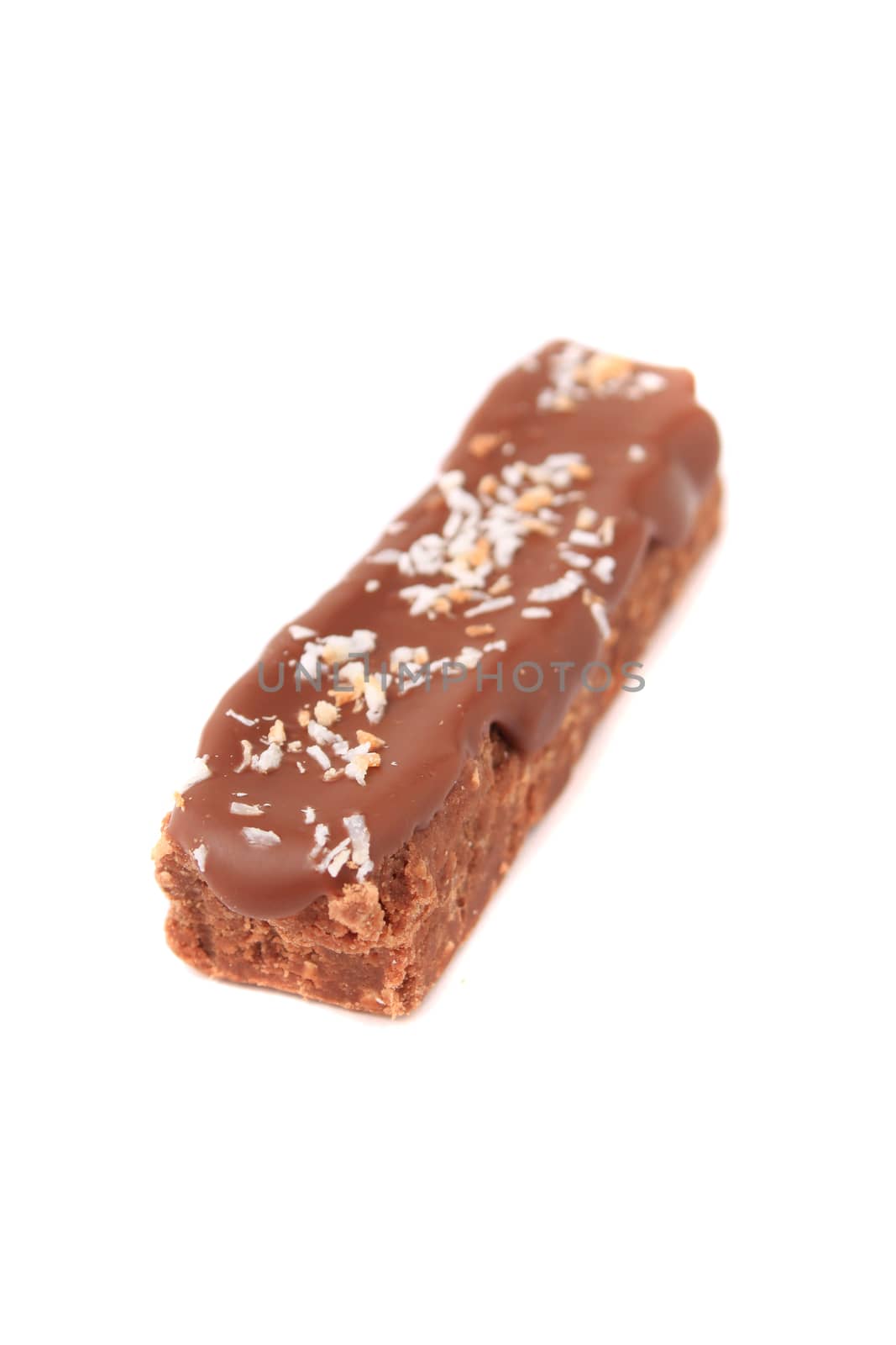 Piece of chocolate fudge with coconut on a white background