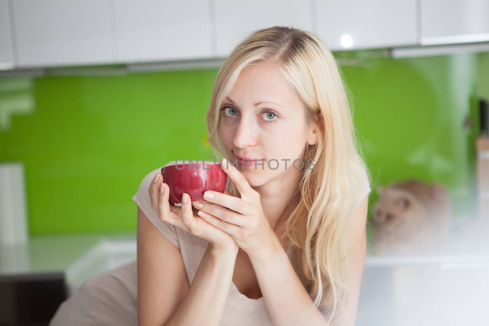 Young woman has her coffee break at home
