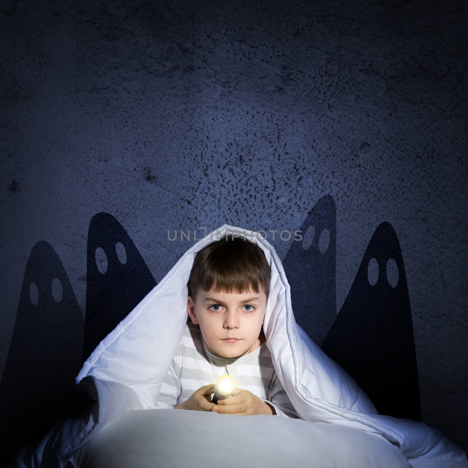 boy under the covers with a flashlight by adam121