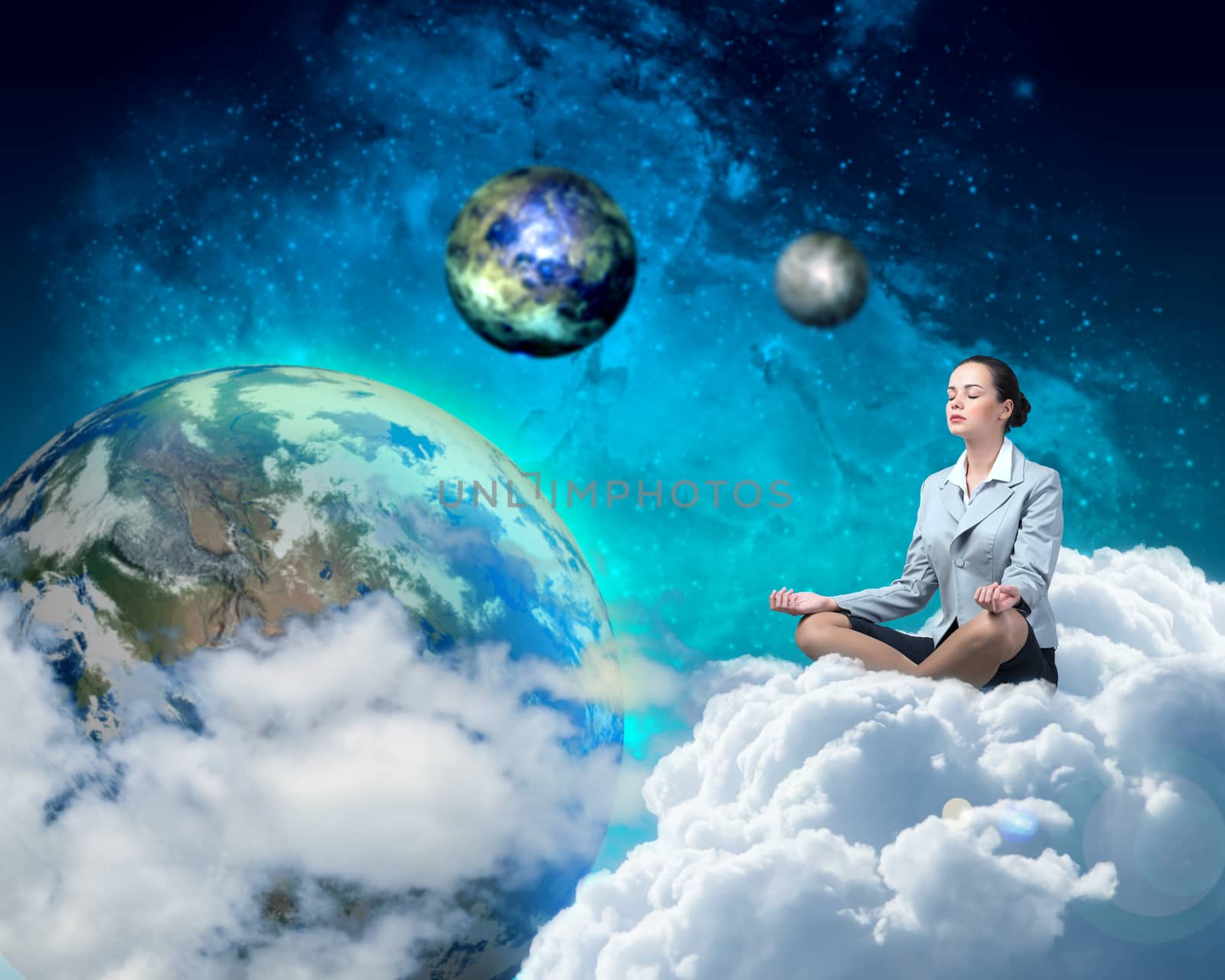 image of a businesswoman meditating in the clouds in space