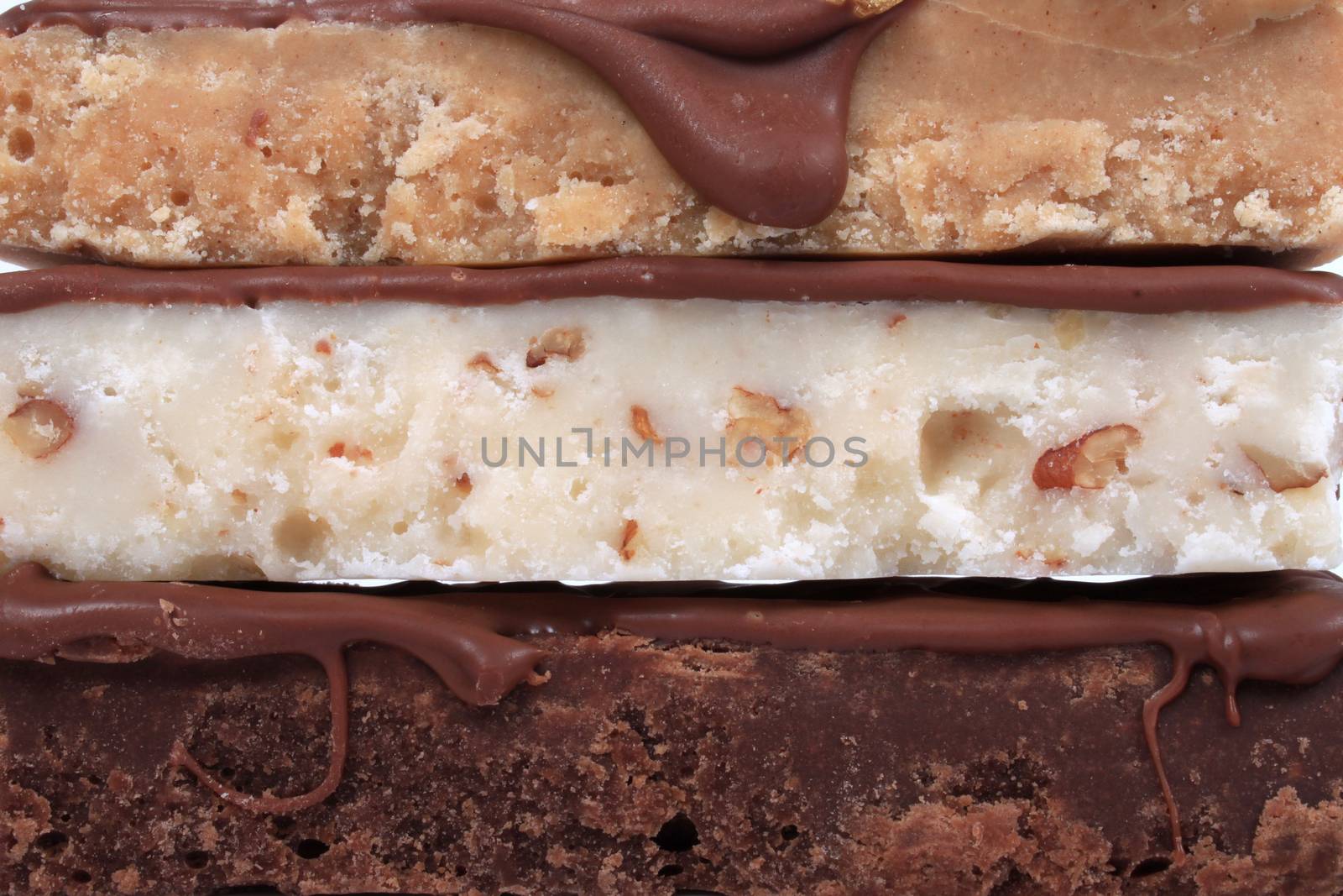 Close up of maple or butterscotch, nut, and chocolate fudge  on a white background