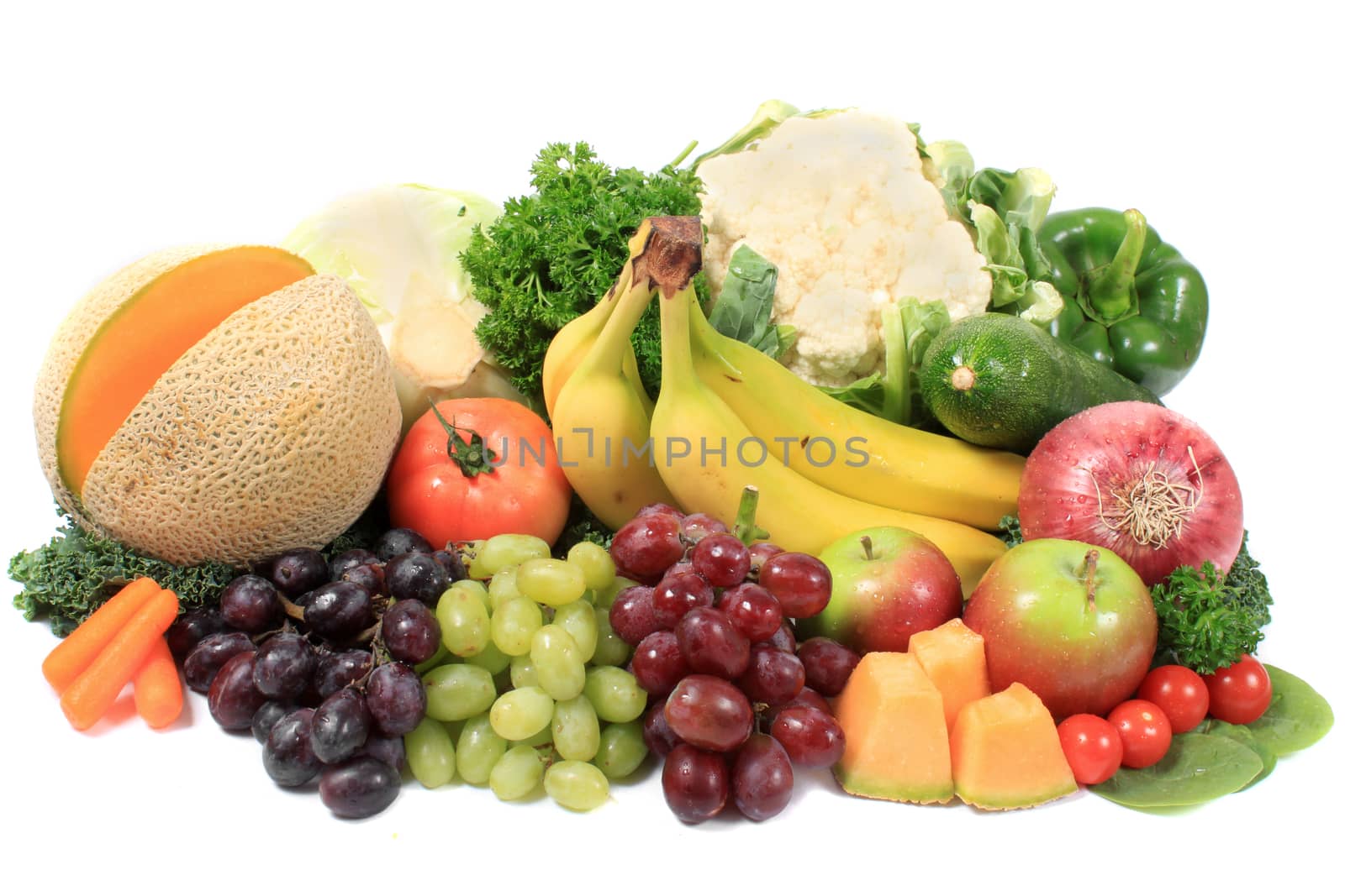 Group of colorful fruits and vegetables like grapes, apples, bananas, and cauliflower