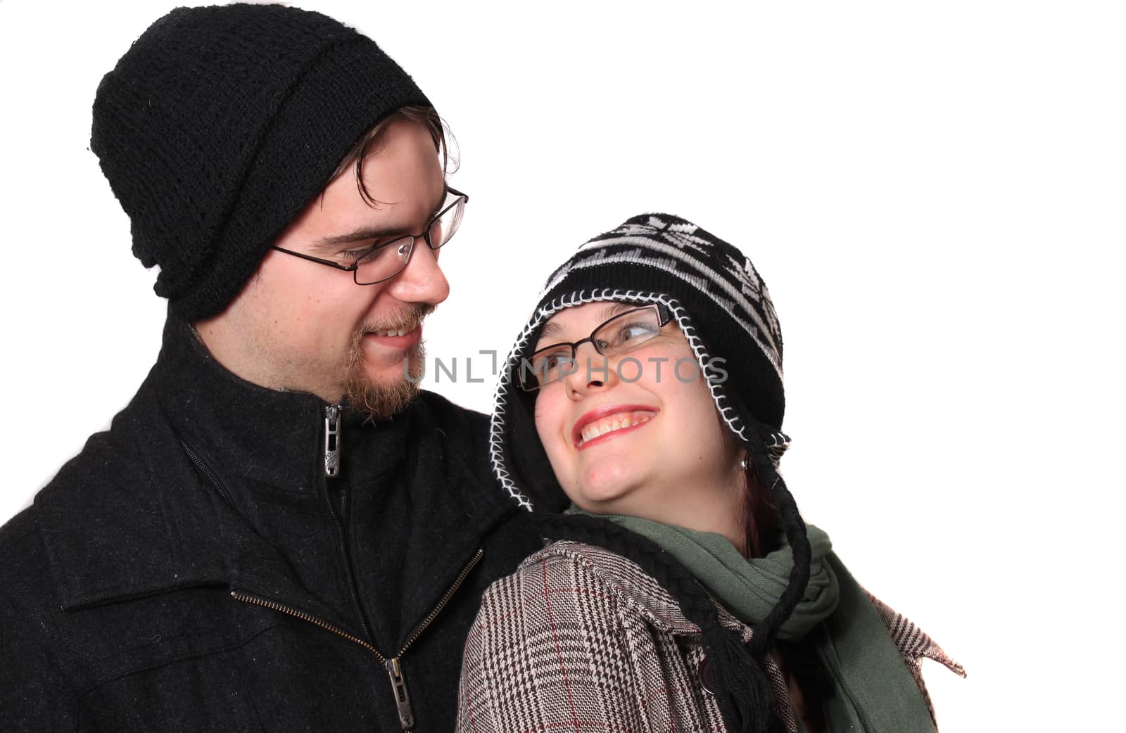 Cute young couple happy together dressed in winter clothing on a white background