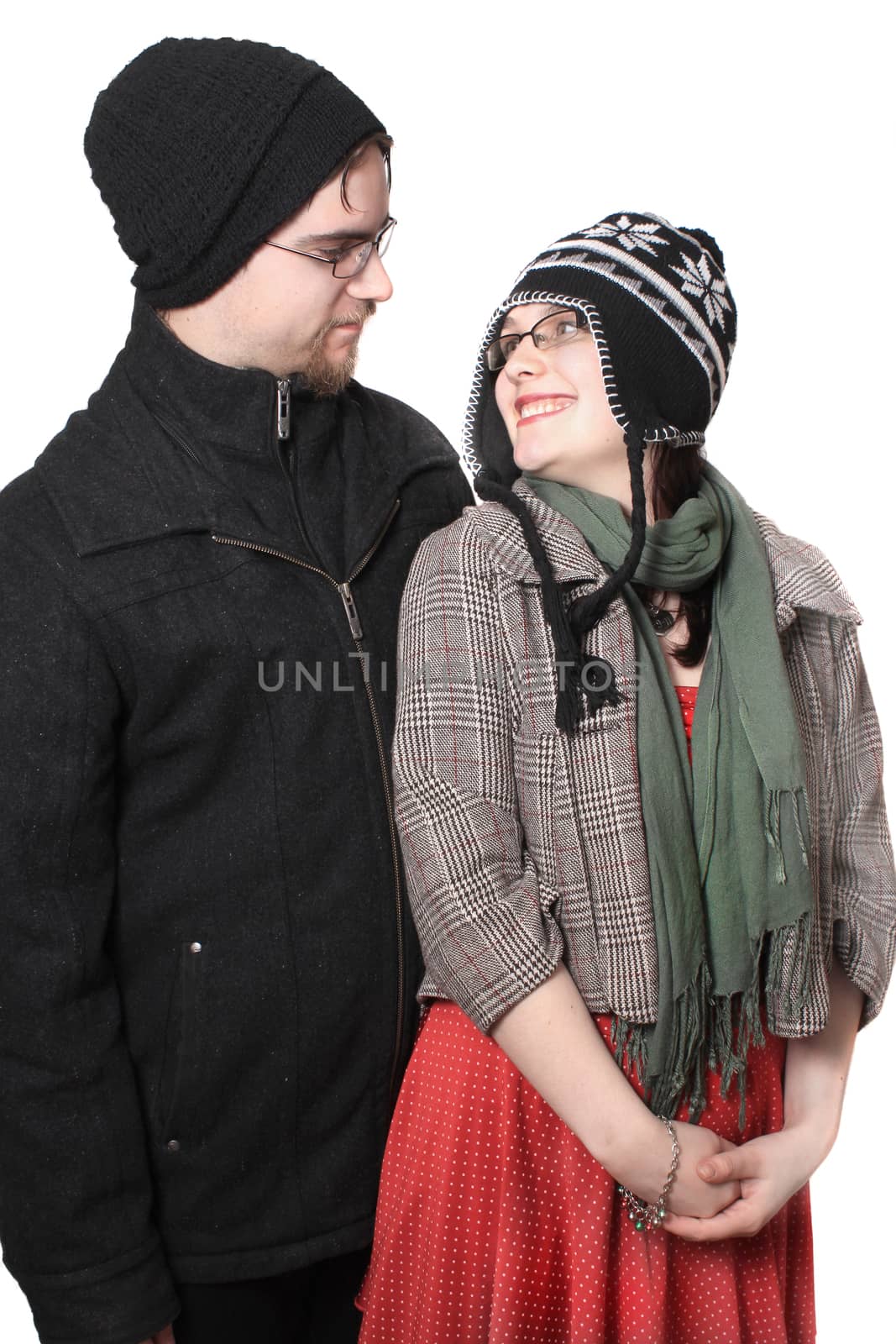 Cute young couple happy together dressed in winter clothing on a white background