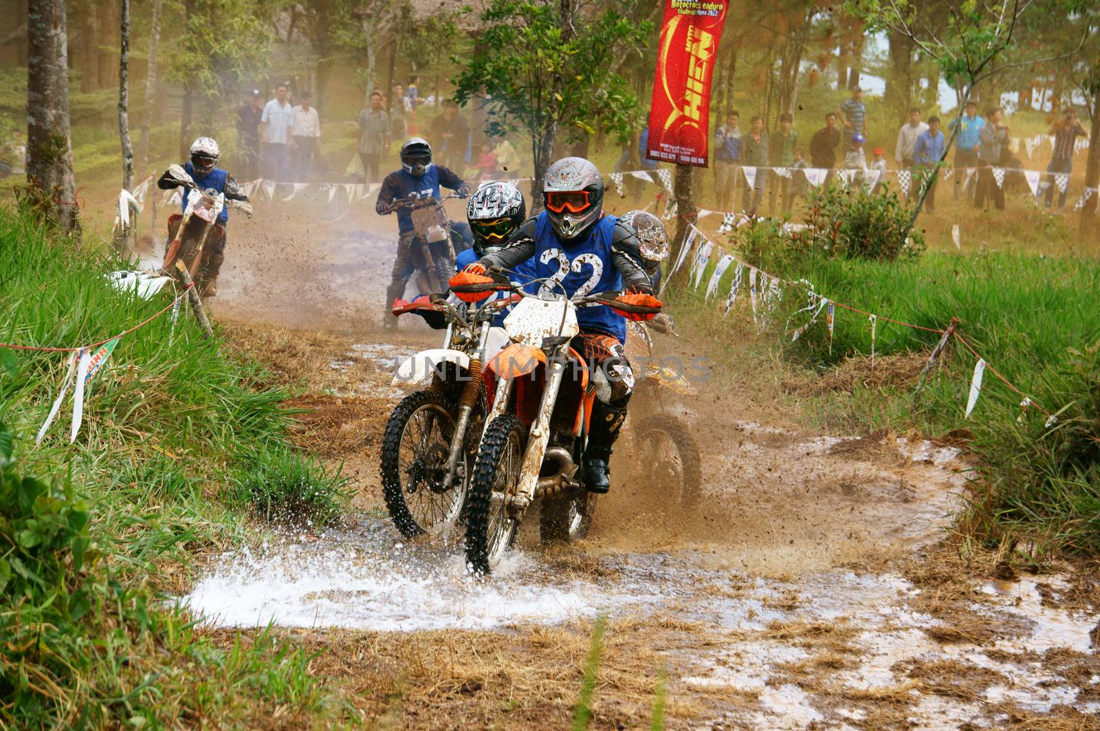 BAO LOC, VIET NAM- DECEMBER 23:  Racer in activity at motorcycle race hole on Bao Loc, Viet Nam, they try to across a marshy stretch of road with violent competition in December 23, 2012               