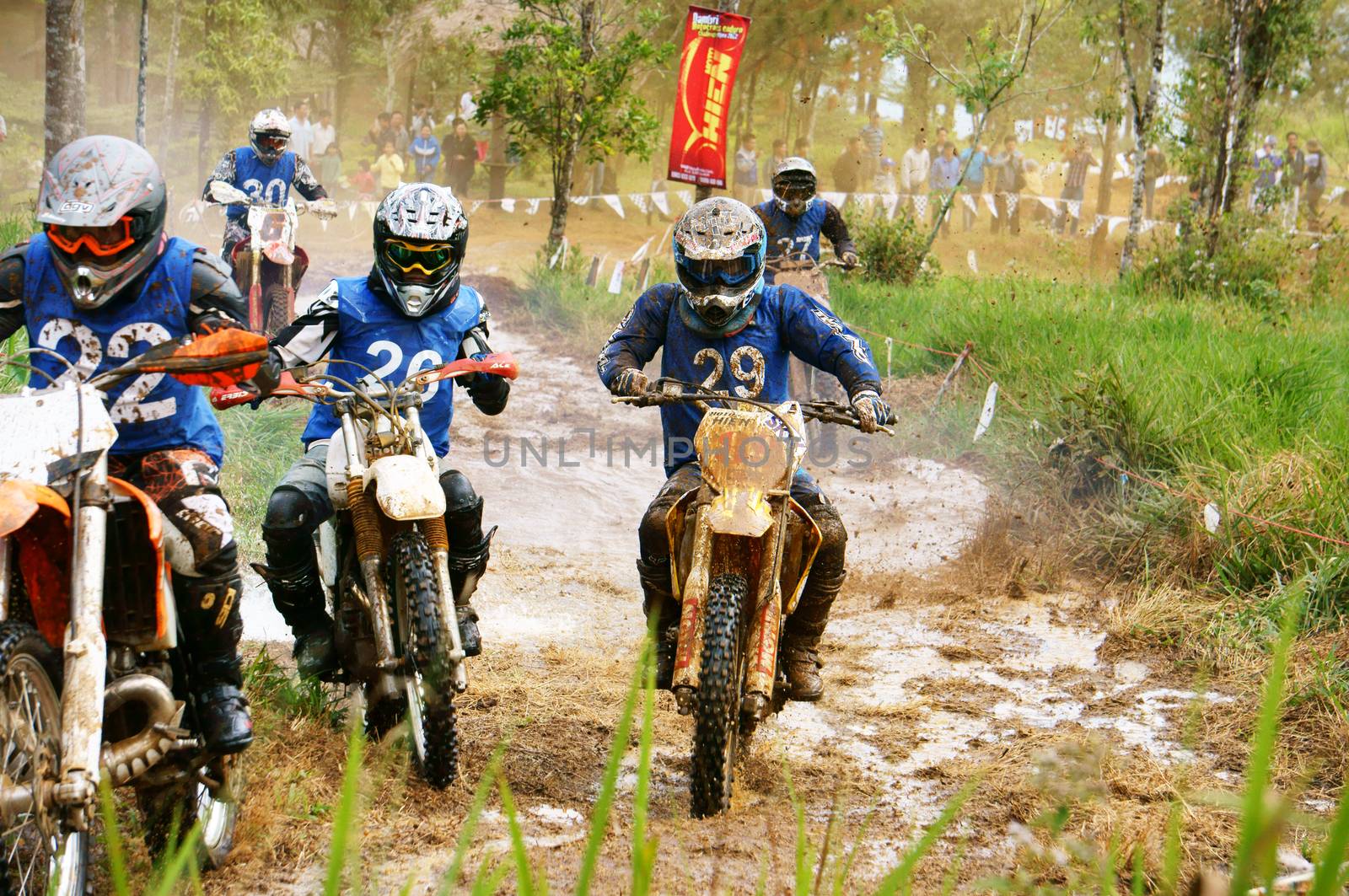 BAO LOC, VIET NAM- DECEMBER 23: Racer in activity at motorcycle race hole on Bao Loc, Viet Nam, they try to across a marshy stretch of road with violent competition in December 23, 2012                