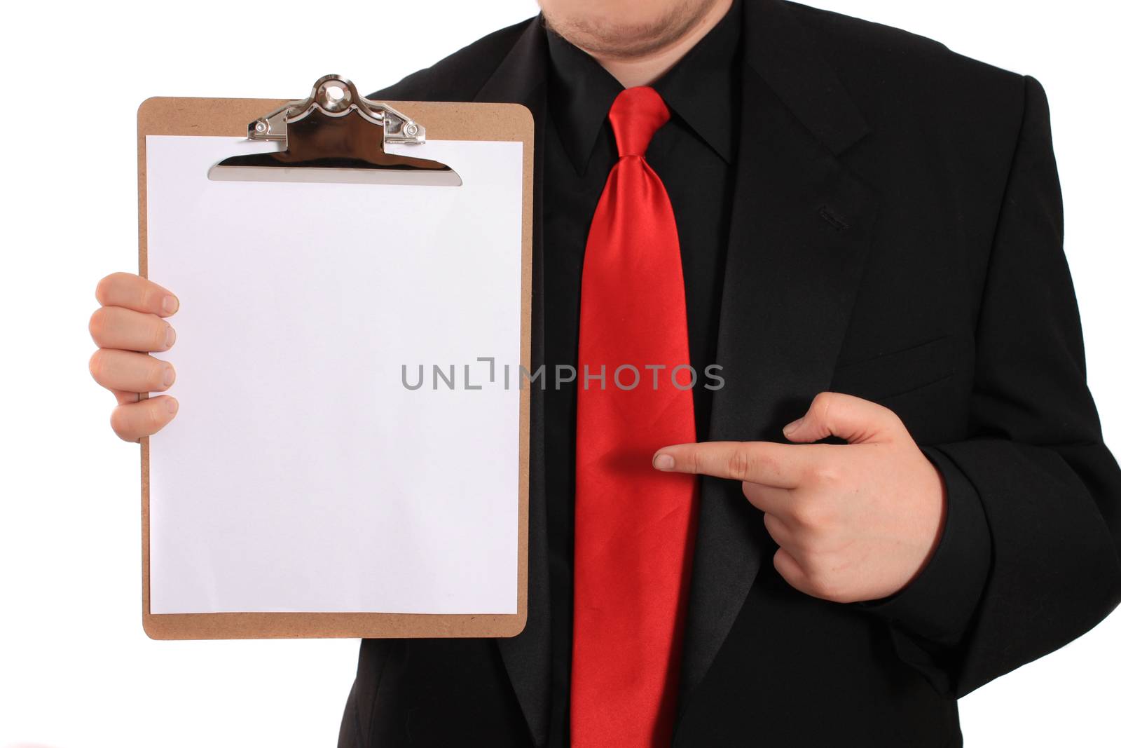 Businessman pointing at and holding a clipboard with a blank page on a white background