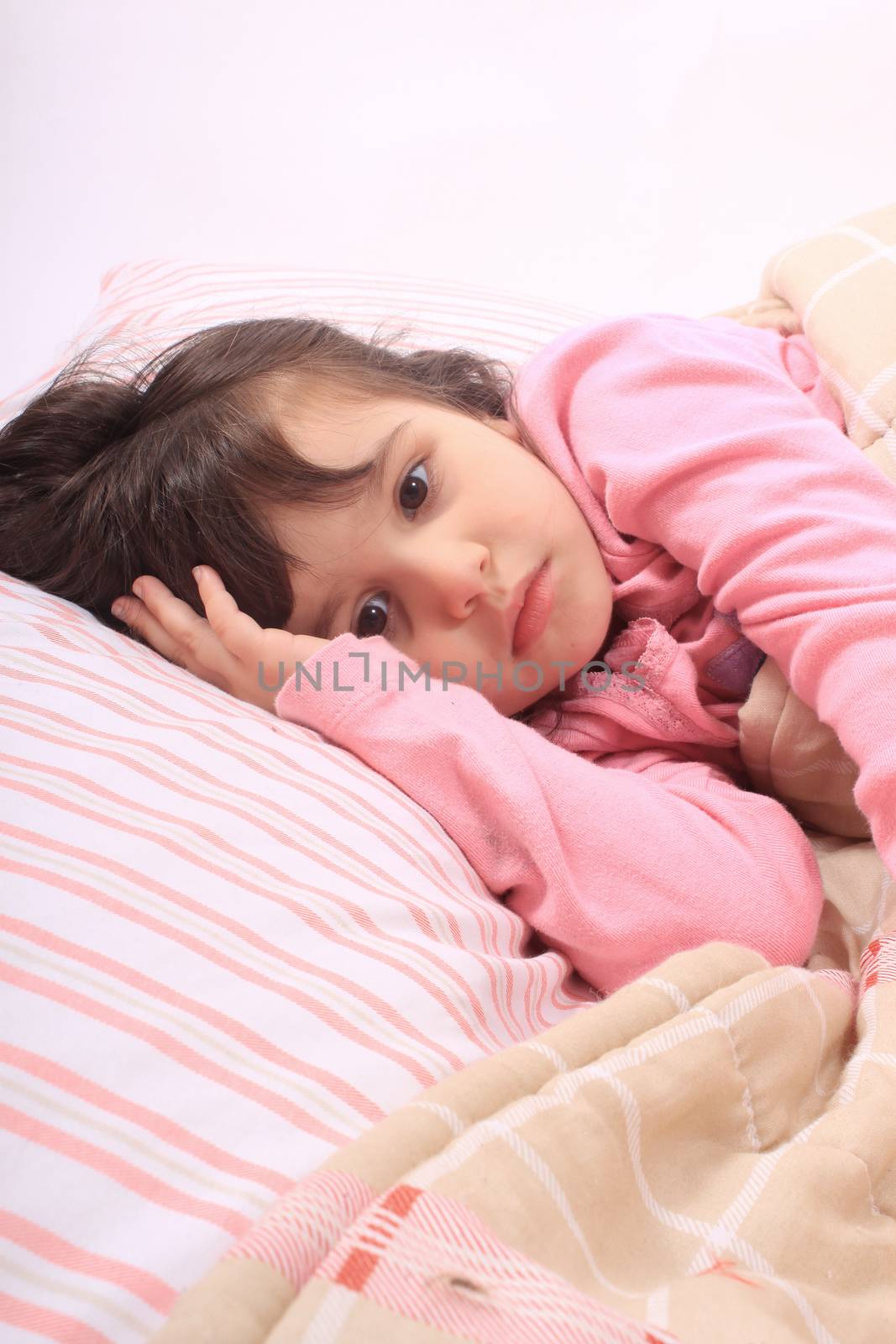 Cute little girl laying in bed and can't fall asleep