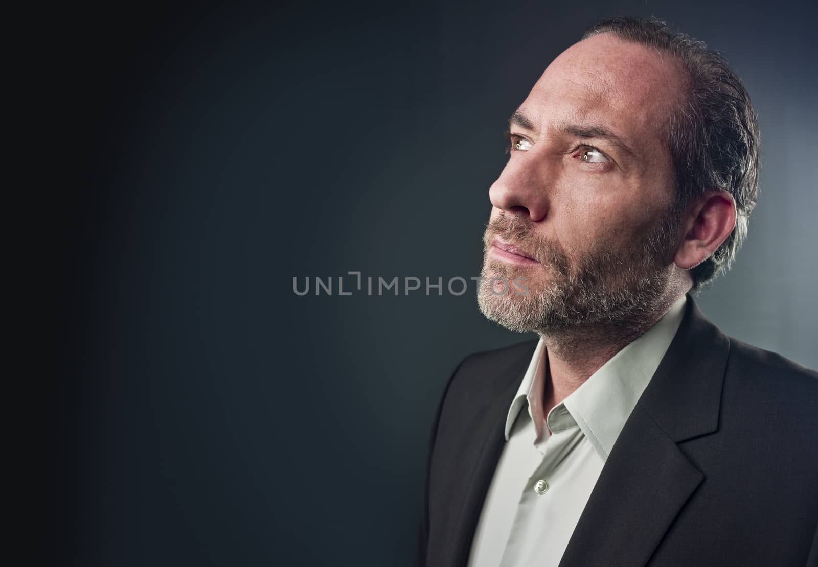 Portrait of a serious mature man isolated over colored background (shot on PhaseOne 45)