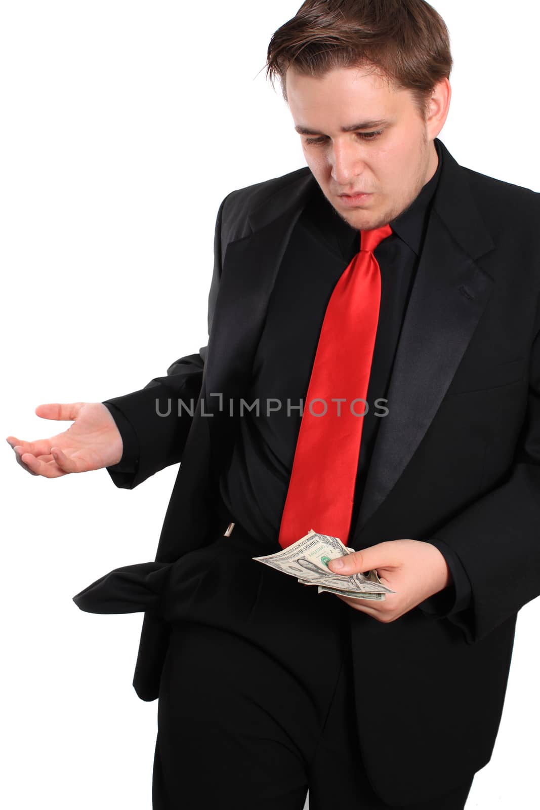 Businessman holding a few dollars and an empty pocket