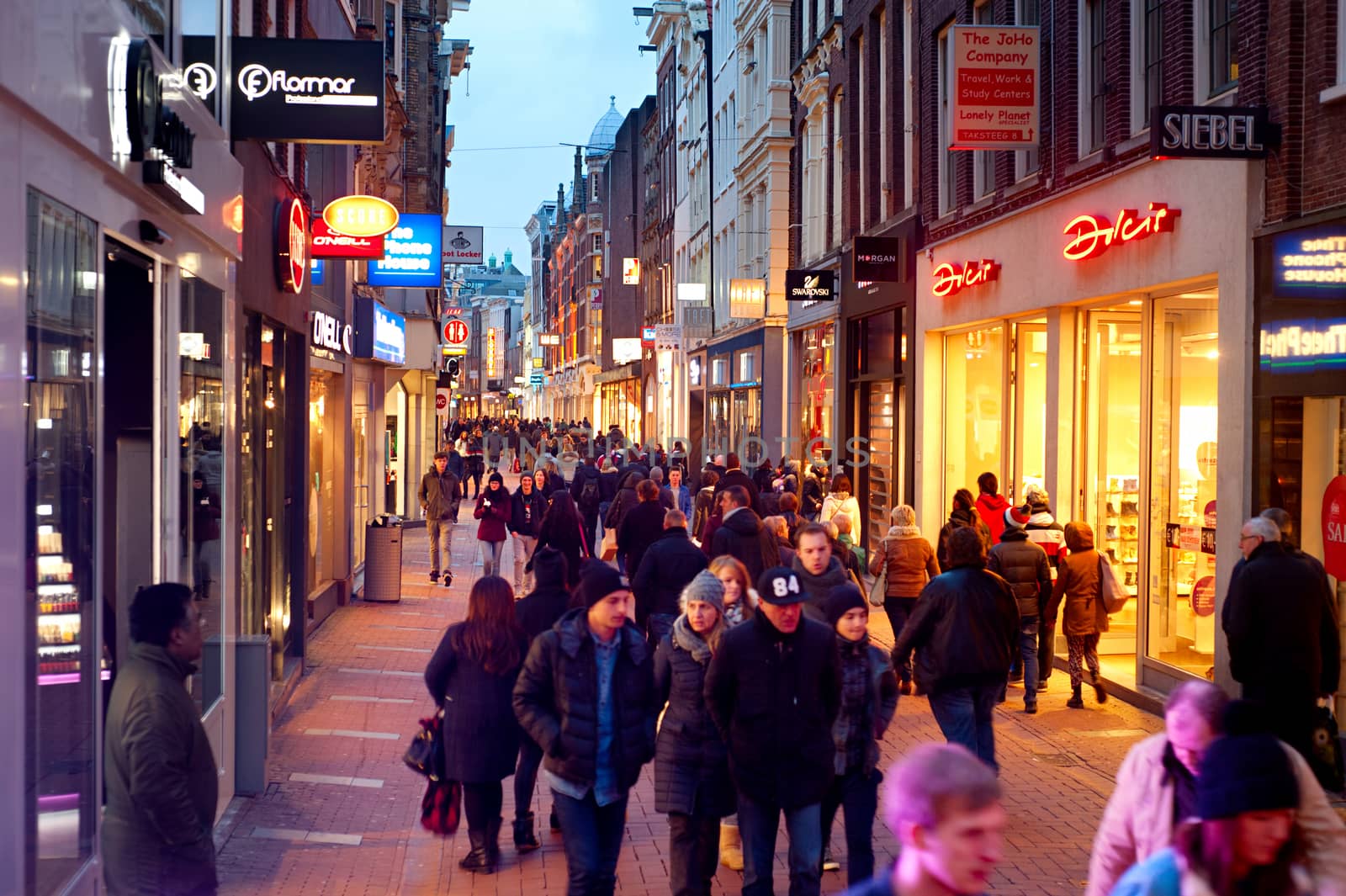 AMSTERDAM, NETHERLANDS - MARCH 01, 2014: Unidentified people walking on Kalverstraat - main shopping street of Amsterdam. The Kalverstraat is the most expensive shopping street in the Netherlands.