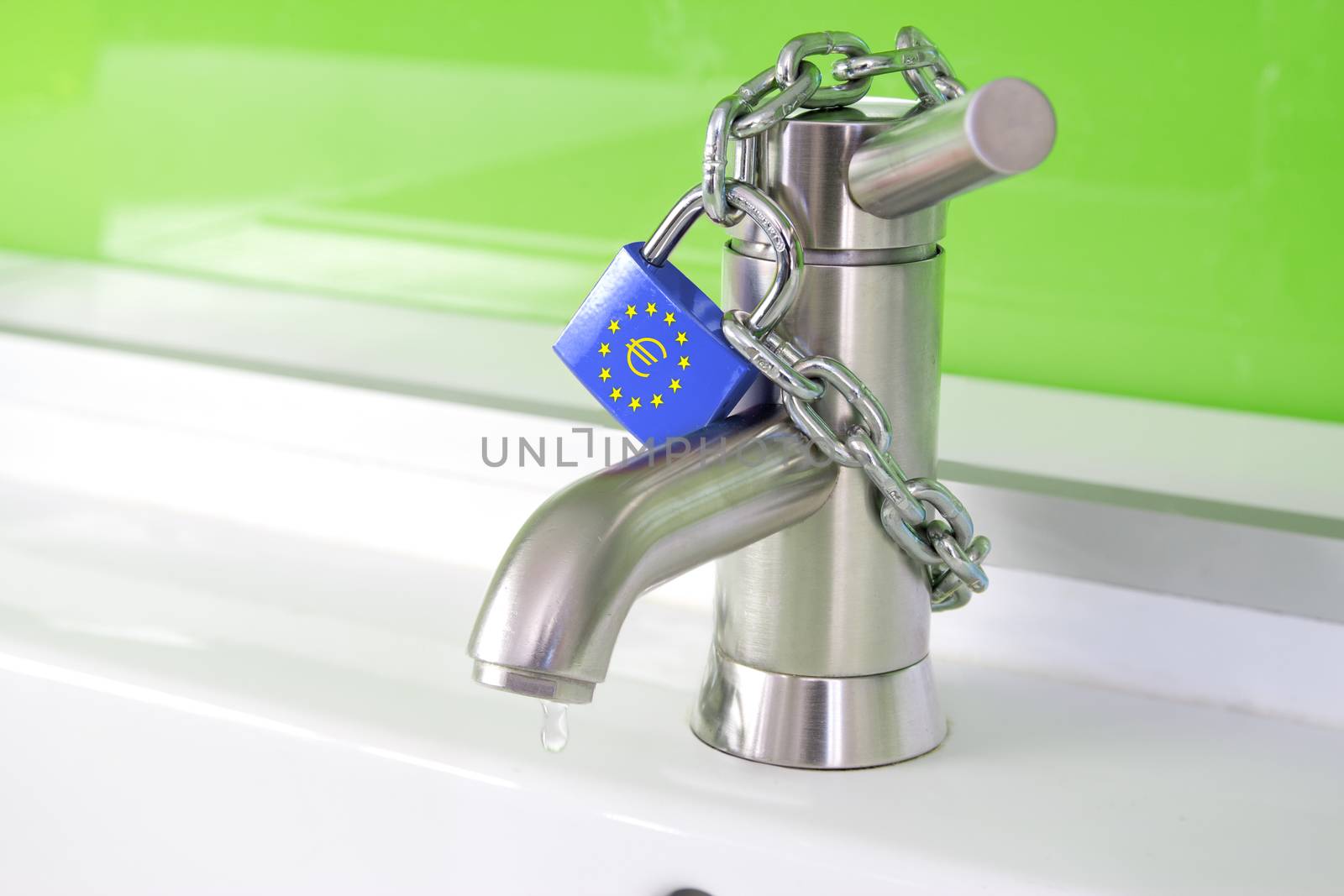 a waterdrop is dripping out of a modern faucet, locked by a lock and chain from the european commission