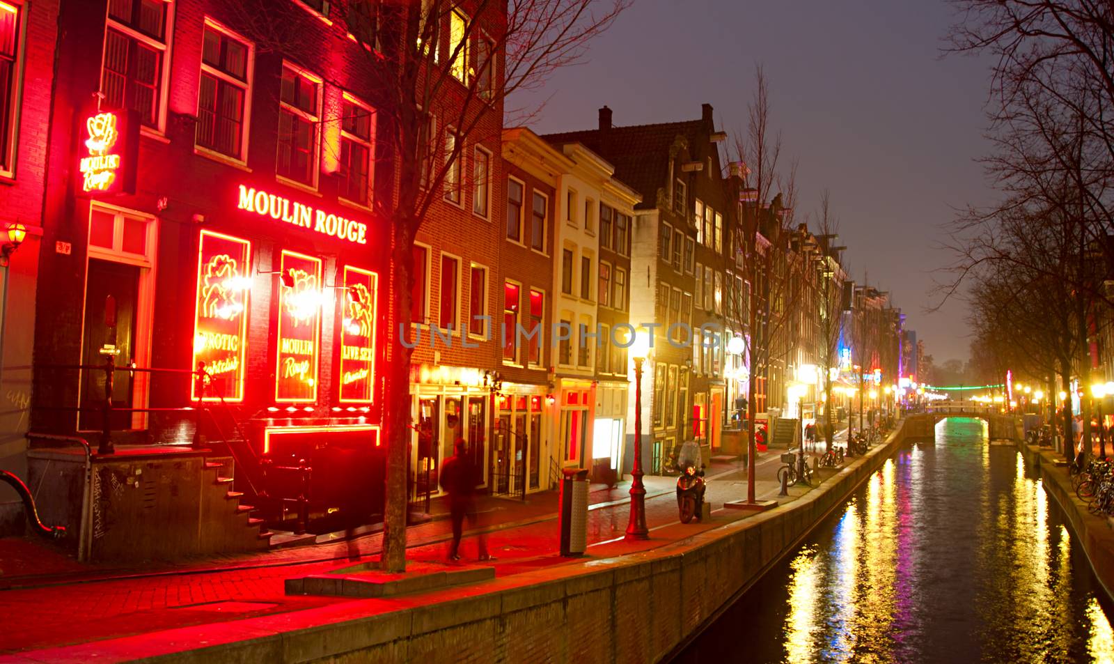 AMSTERDAM, NETHERLANDS - MARCH 10, 2013: Red-light district in Amsterdam. There are about three hundred cabins rented by prostitutes in the area.