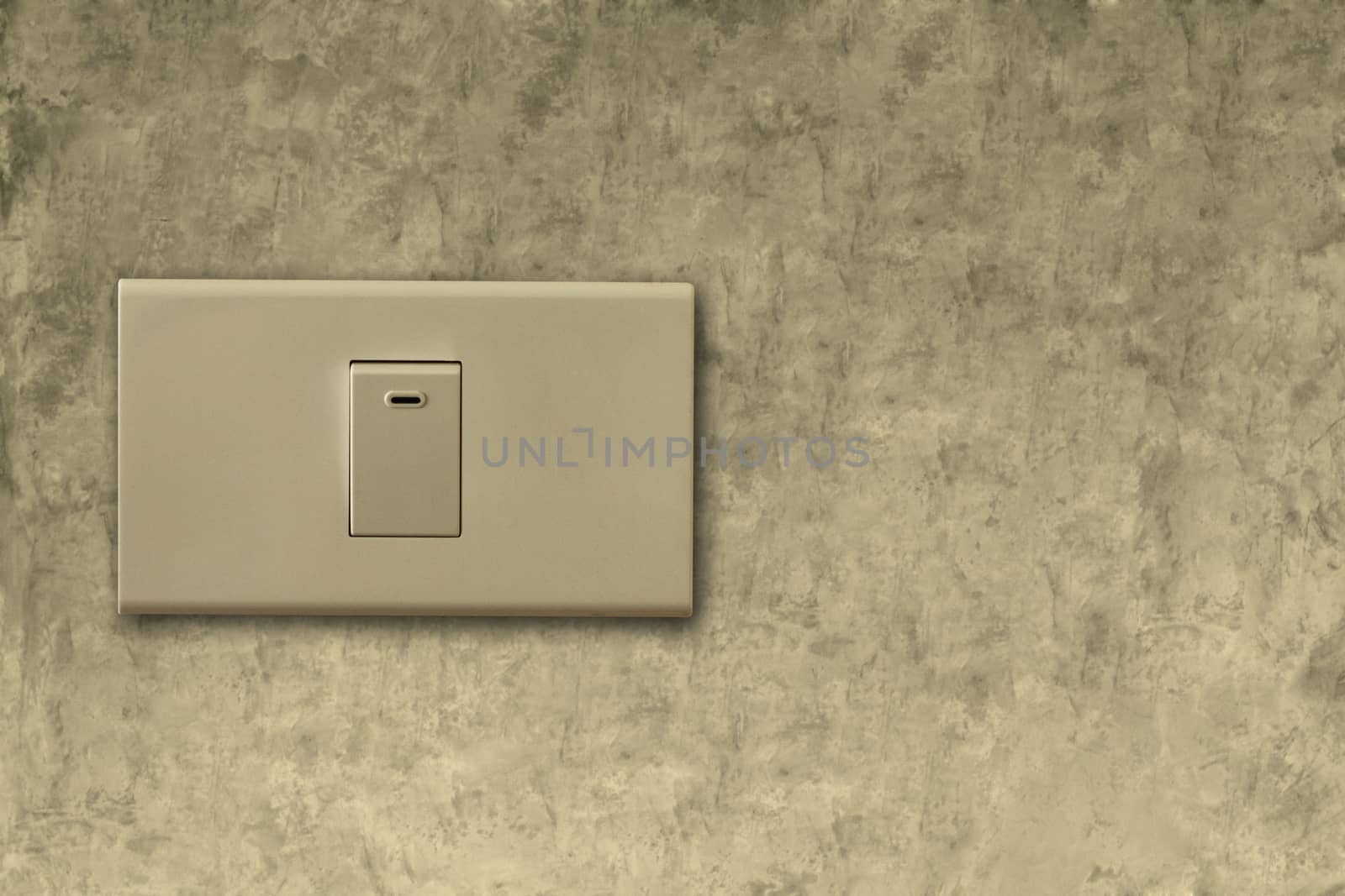 Light switch on the cement wall background