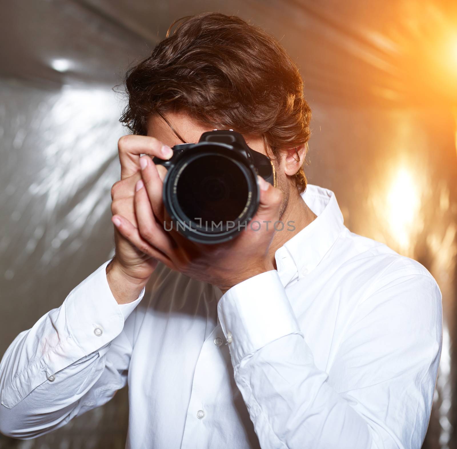 Young handsome photographer on the hunt