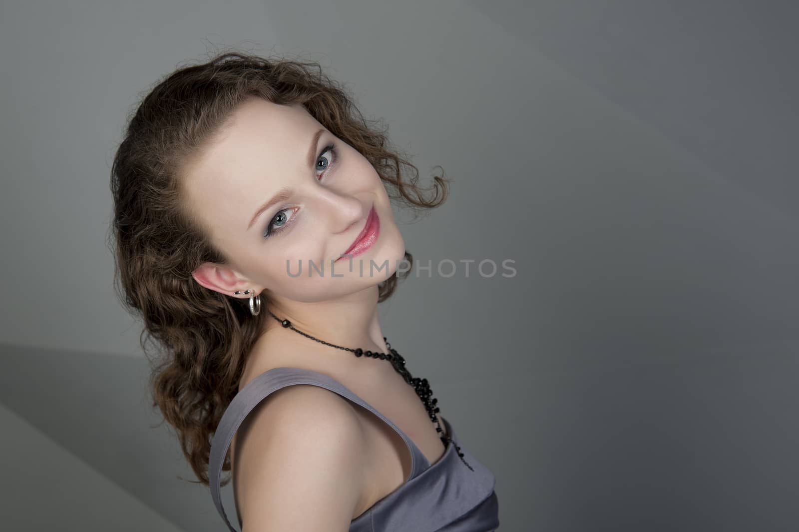 woman in a grey dress with a grey background