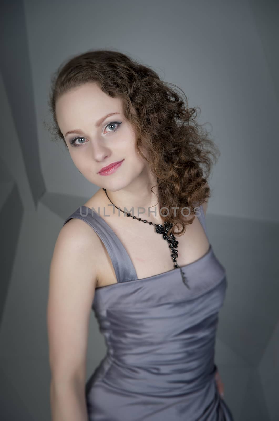 woman in a grey dress with a grey background