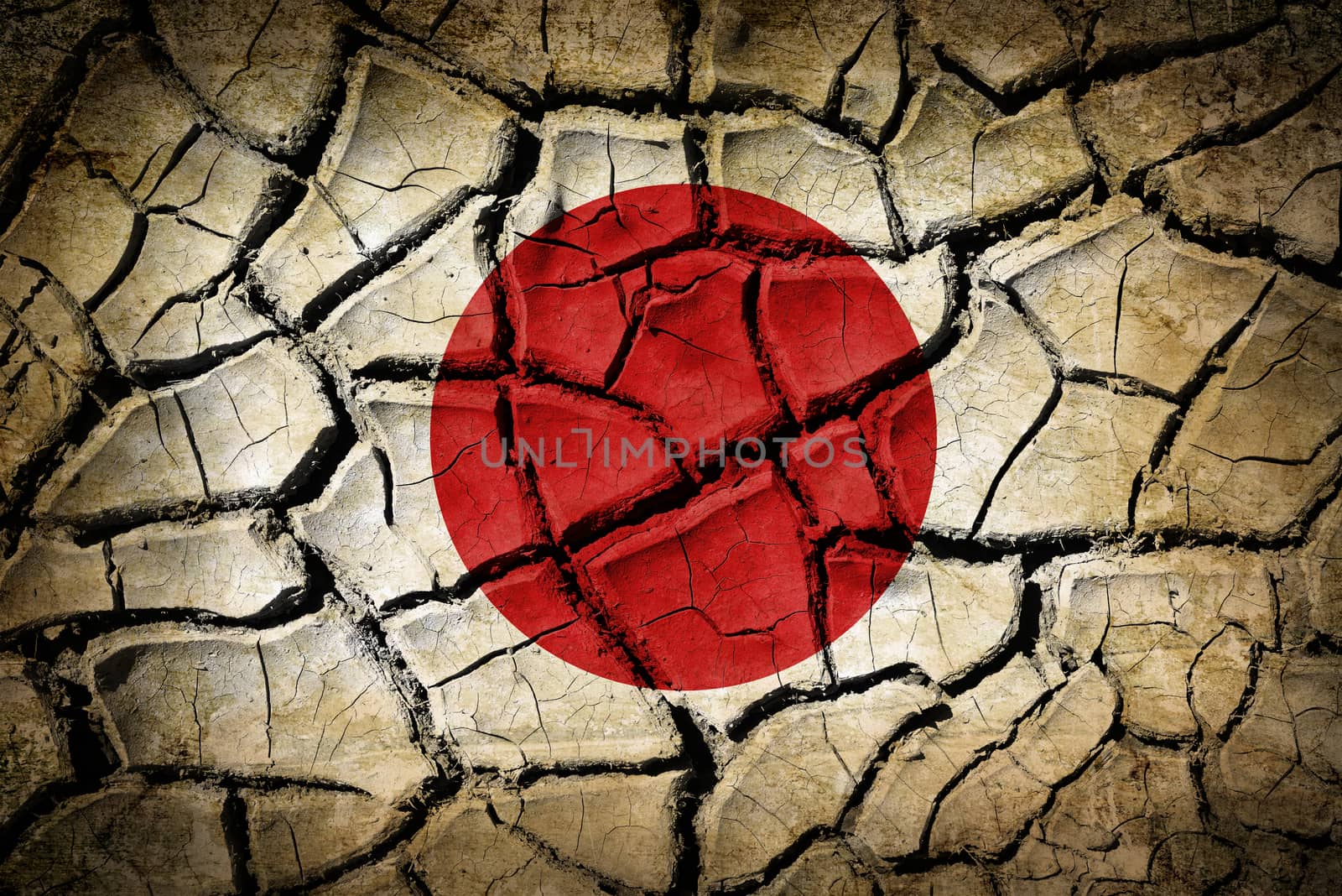 Abstract natural background with cracked earth texture and japan flag on it. Symbol of earthquake