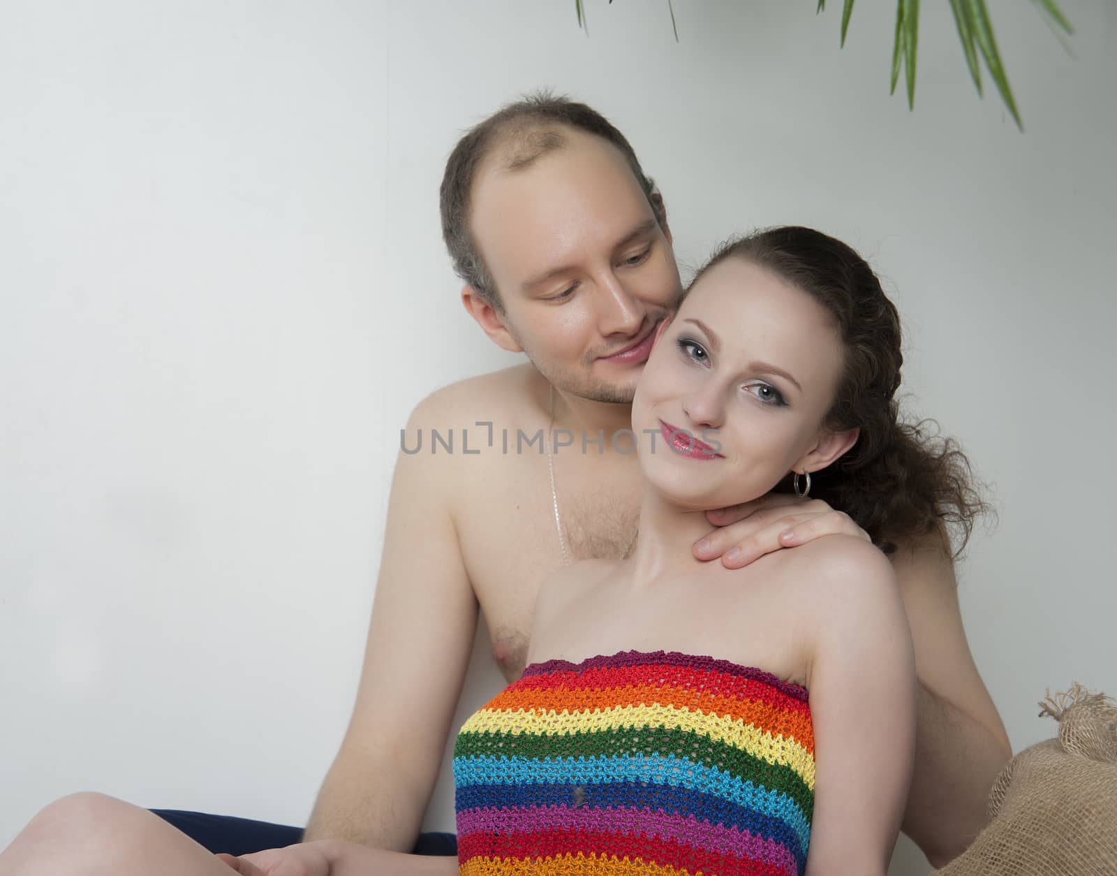 young couple under a palm tree in the Studio