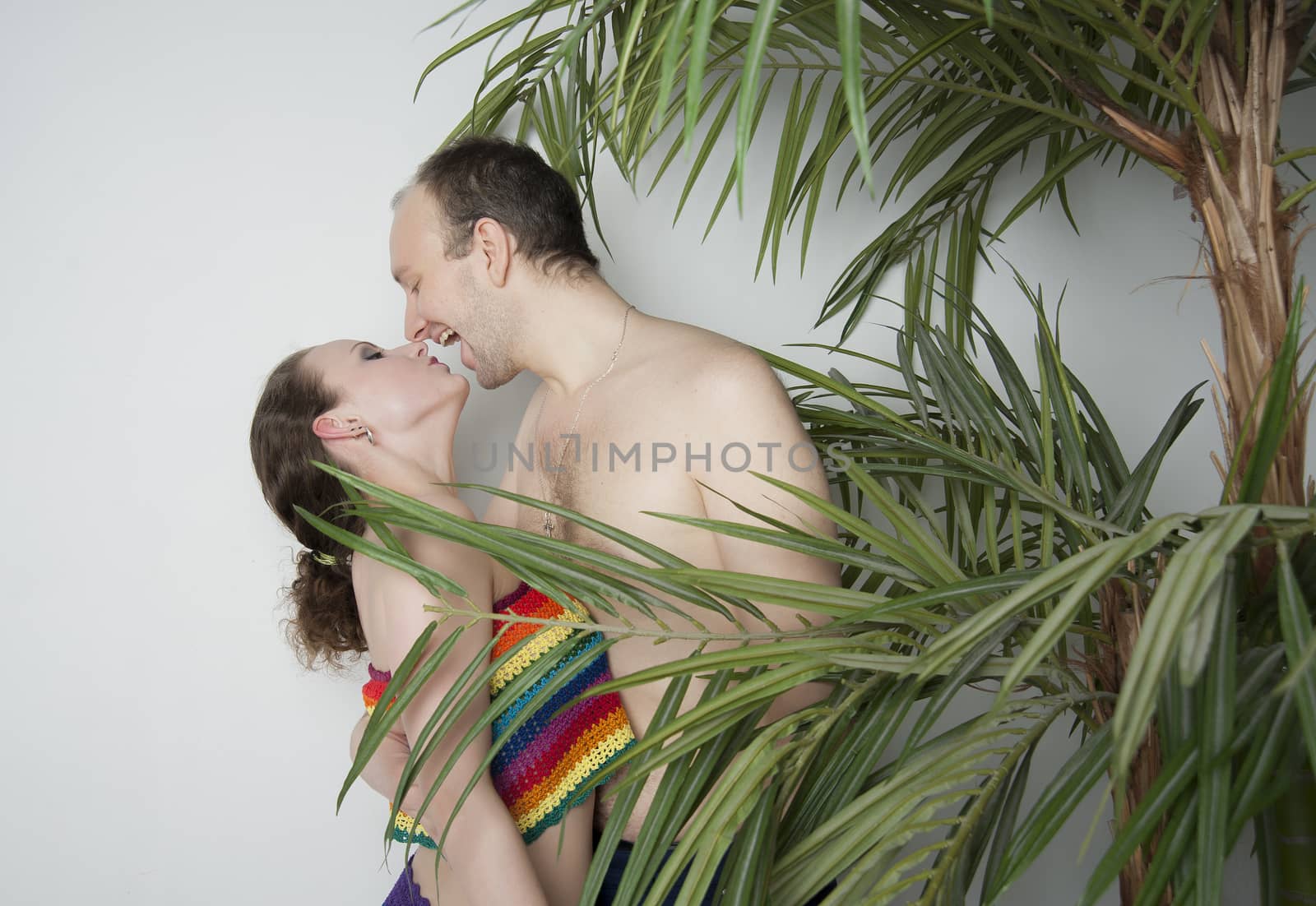 young couple under a palm tree in the Studio