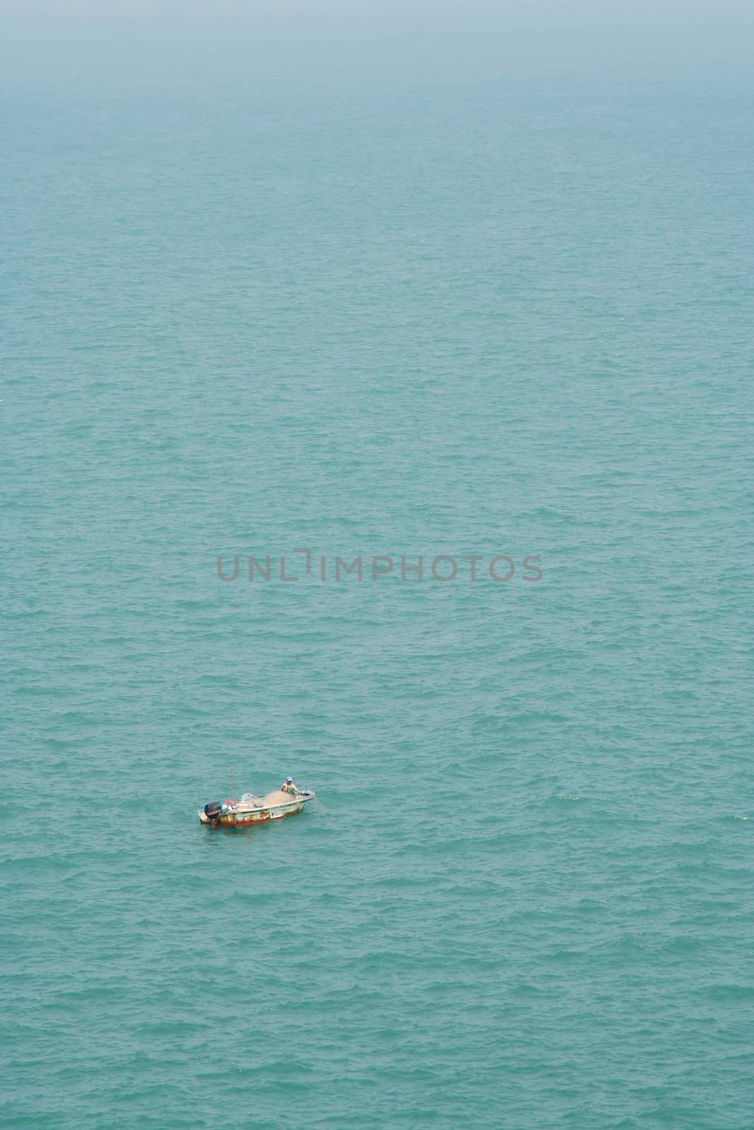 Fishmen on small boat in the sea