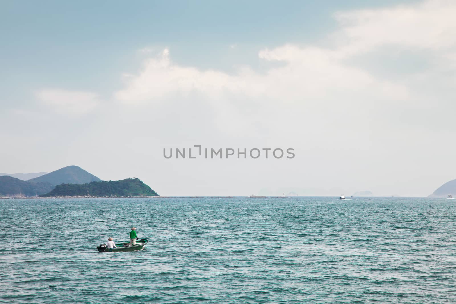 Fishmen on small boat in the sea