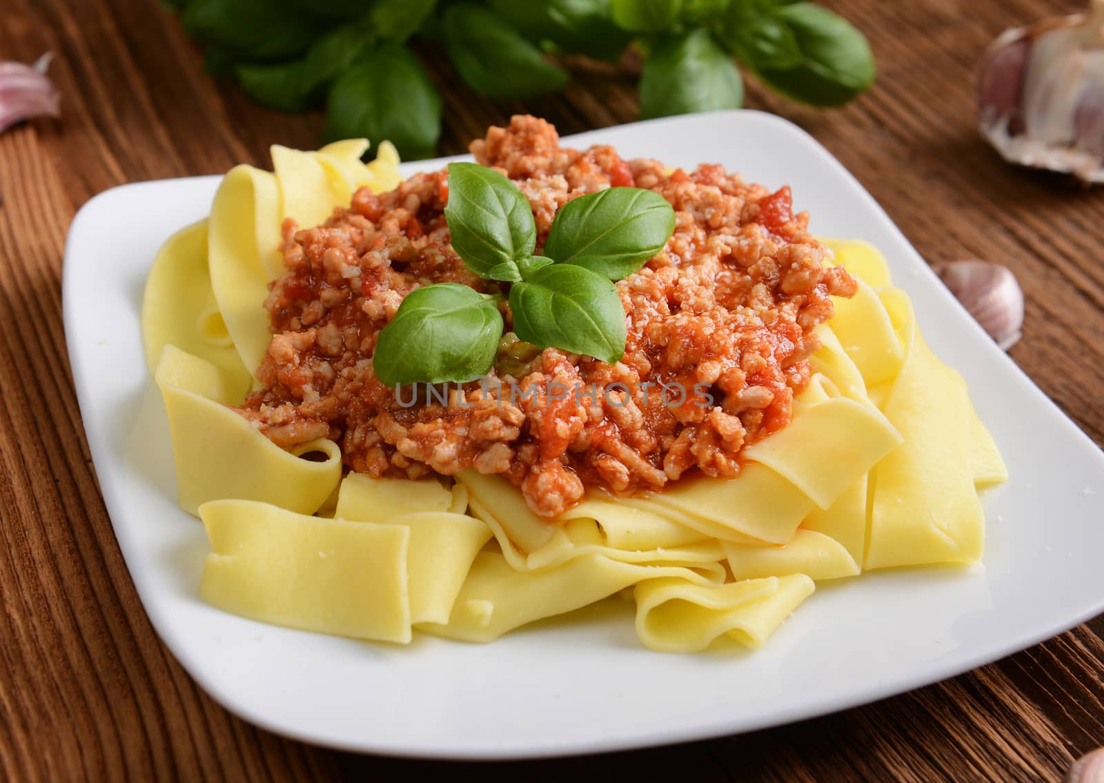 tagliatelle with cheese sauce garnished with basil leaves