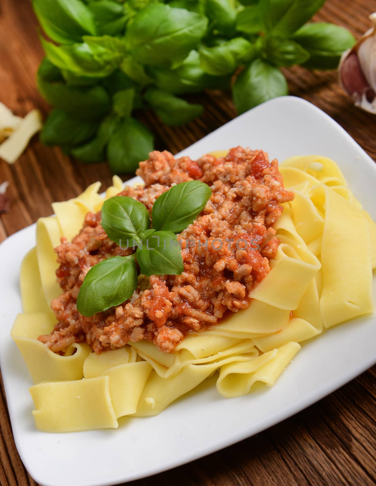tagliatelle with cheese sauce garnished with basil leaves
