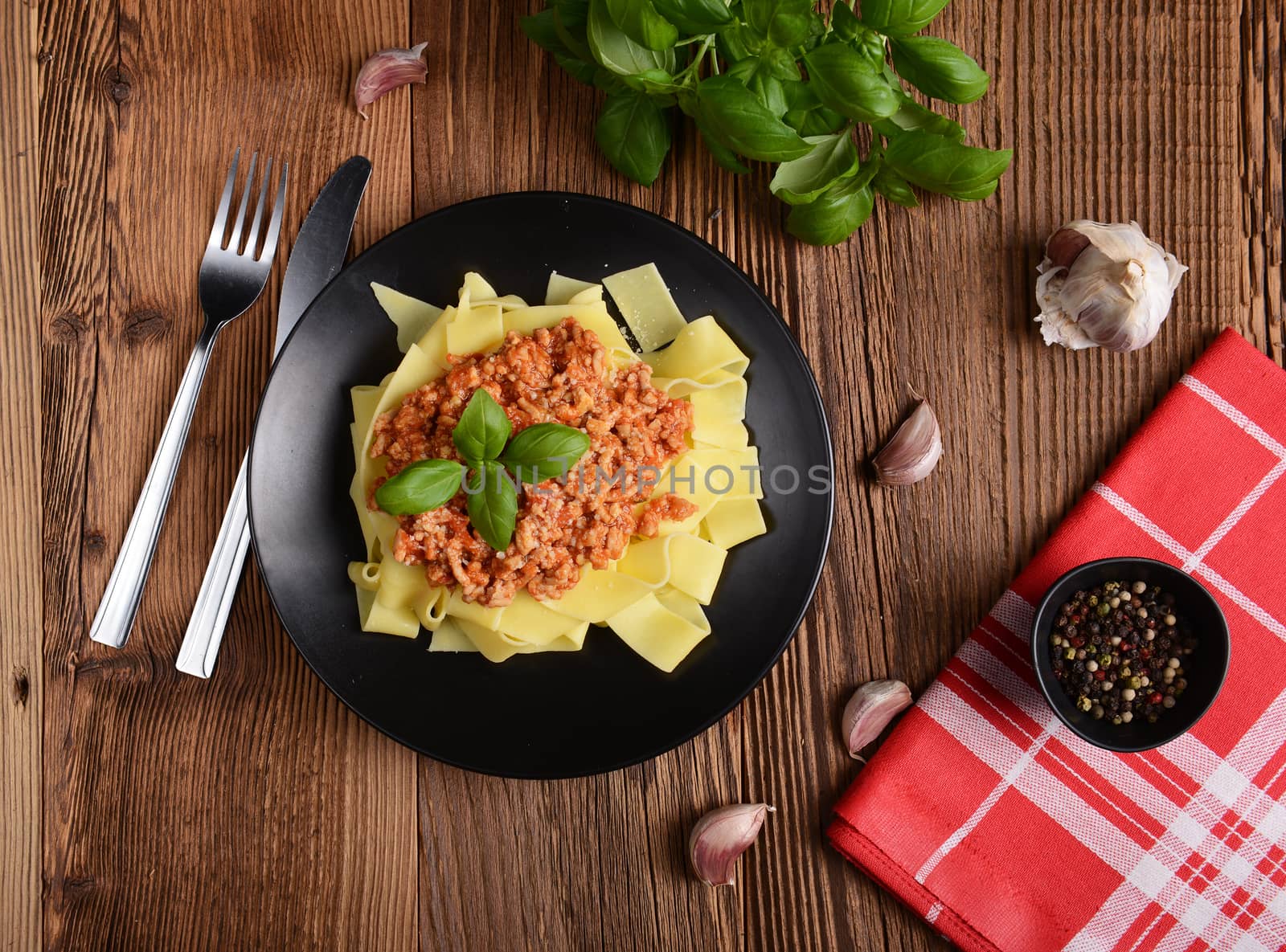 tagliatelle with cheese sauce garnished with basil leaves