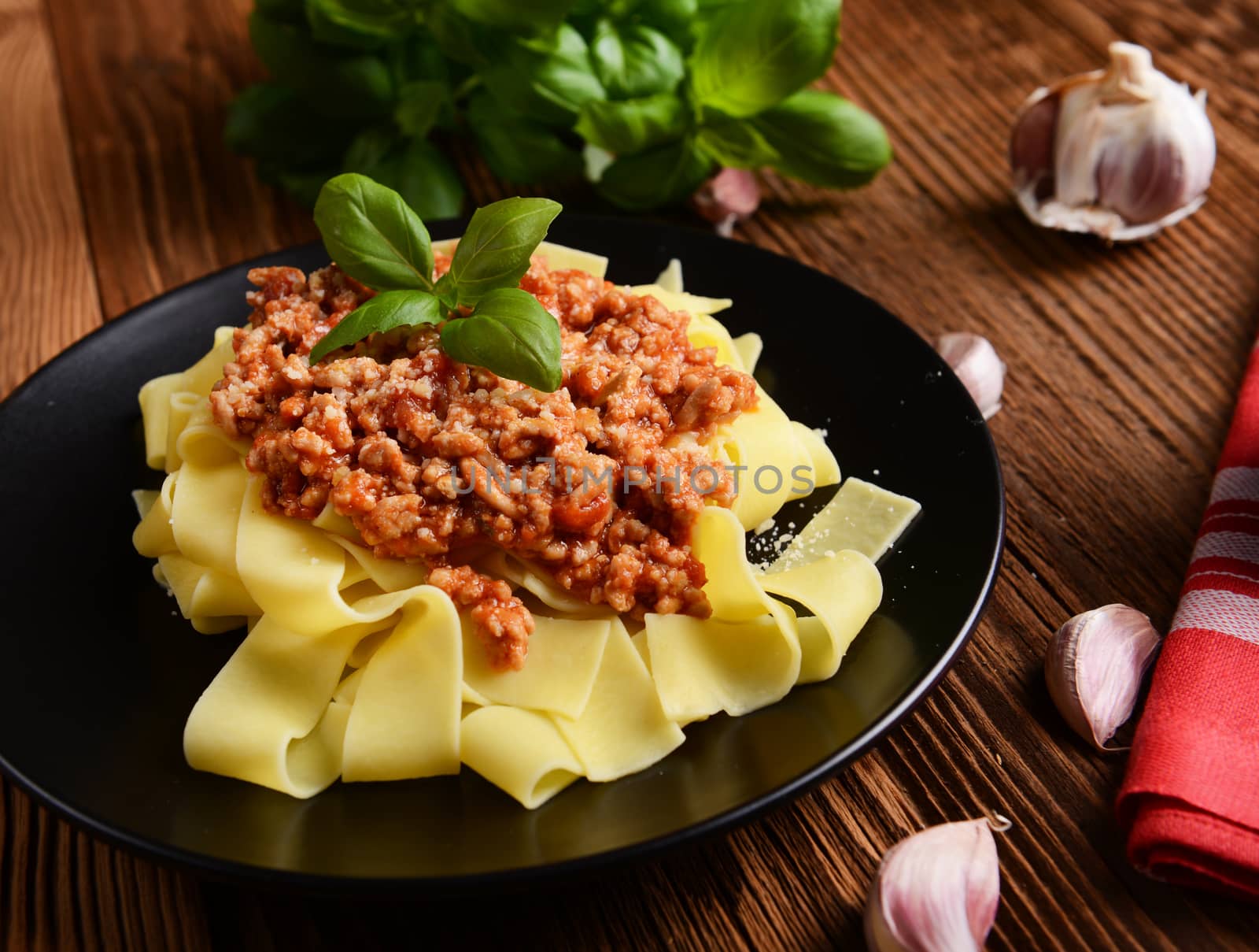 tagliatelle with cheese sauce garnished with basil leaves