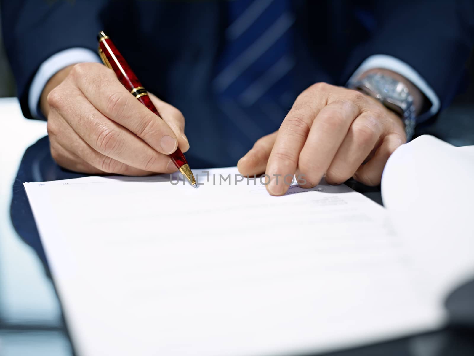 Close up of businessman signing a contract. by aa-w