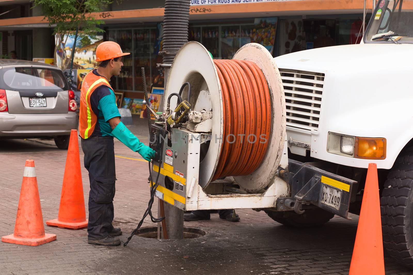 LIMA, PERU - FEBRUARY 11, 2012: Unidentified person of the Concyssa S.A. company cleaning the sewage with the help of a truck on February 11, 2012 in Miraflores, Lima, Peru