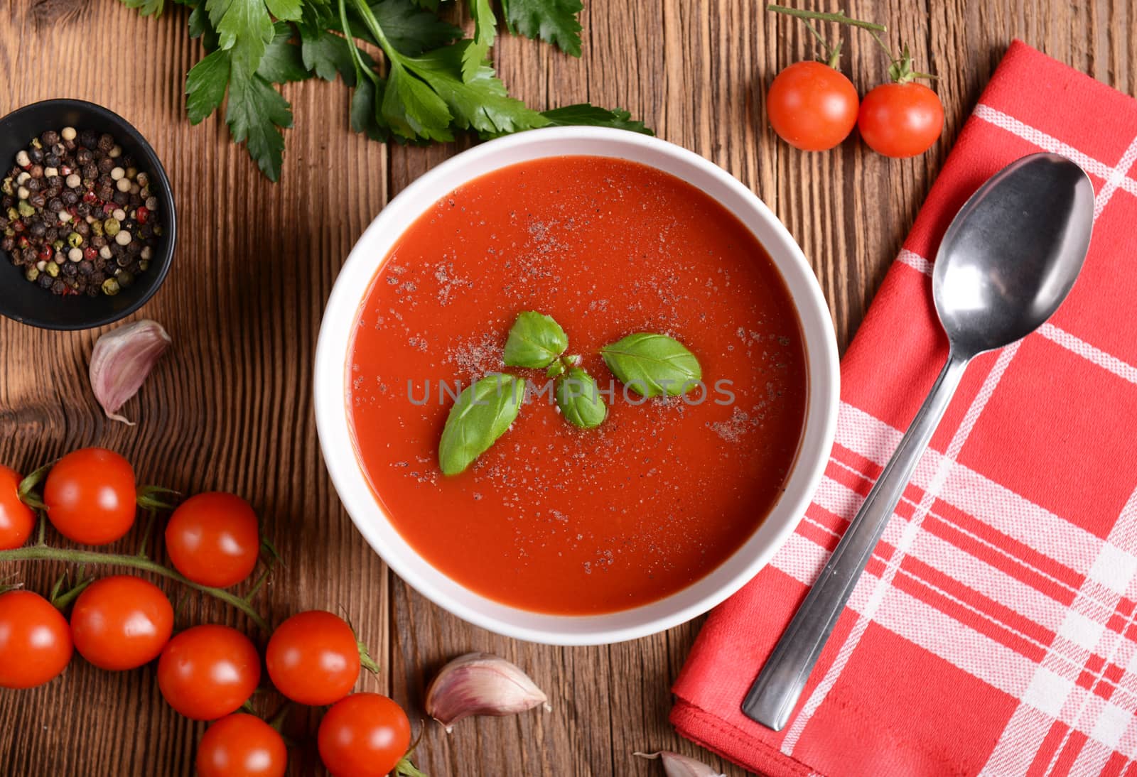 Tasty tomato soup on wooden background