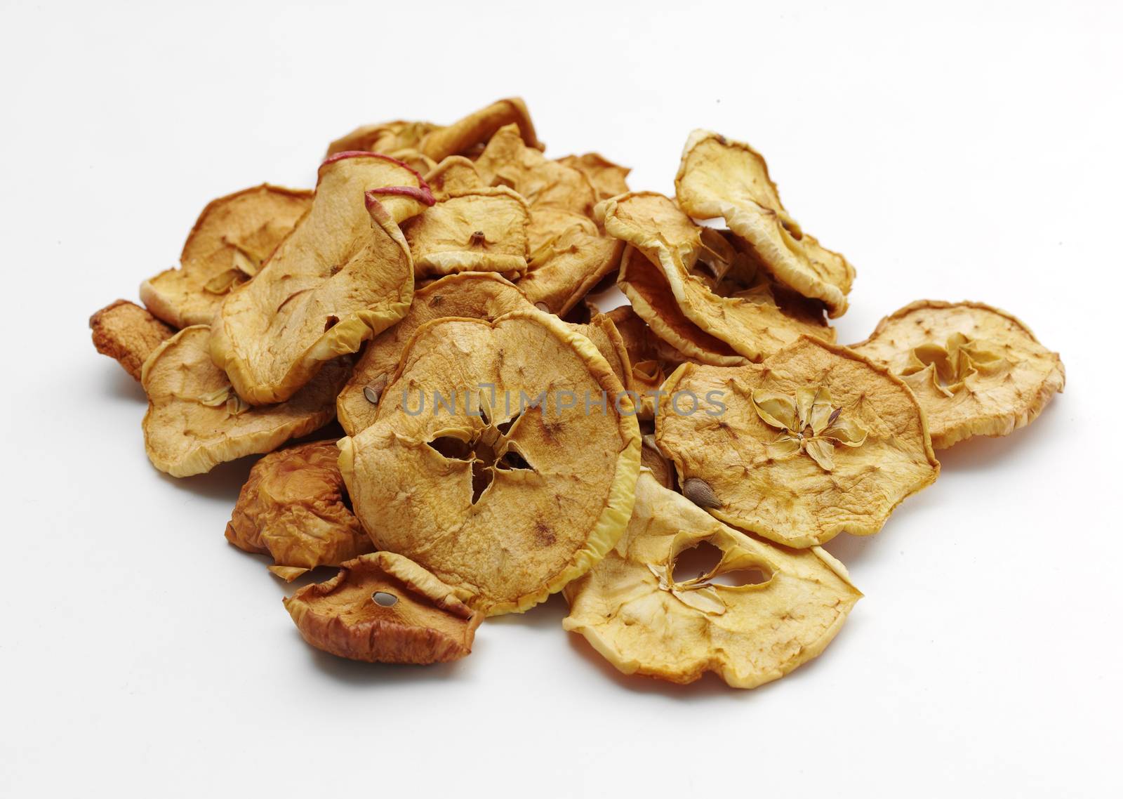 heap of tasty dried apples over white background