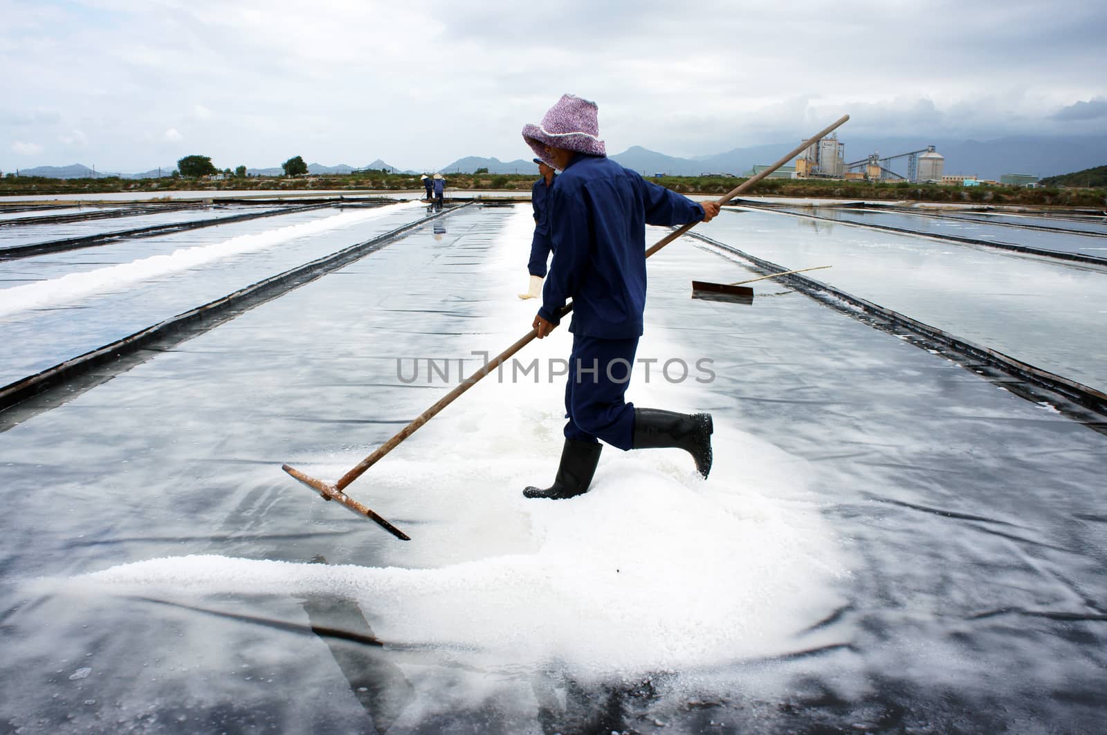 BA RIA, VIET NAM- FEBRUARY 3: Salt worker working on salina,they harvesting white salt in  Ba Ria, Viet Nam on February 4, 2013
